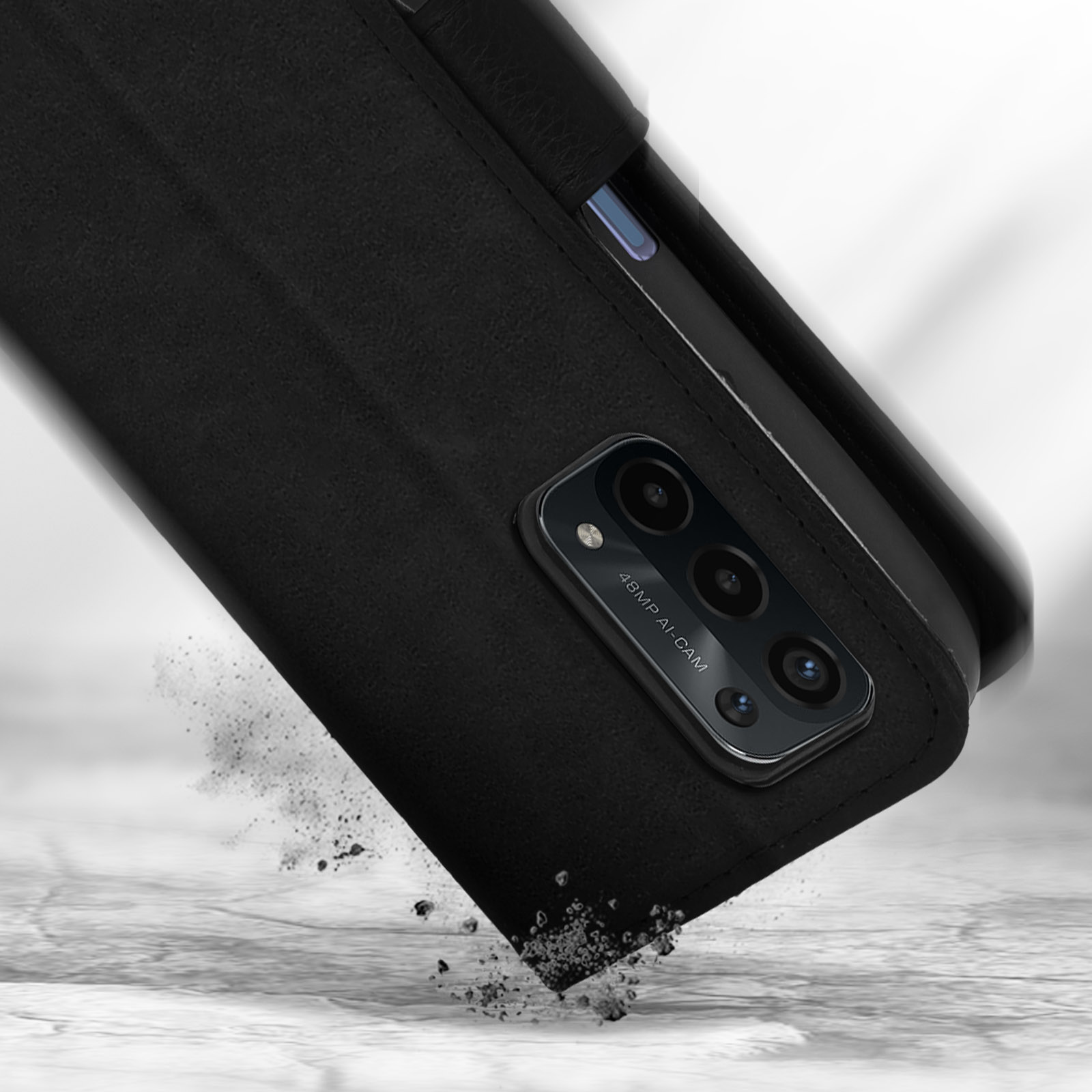Téléphone noir avec caméra IA 48MP tombant, débris volants sur des dalles.