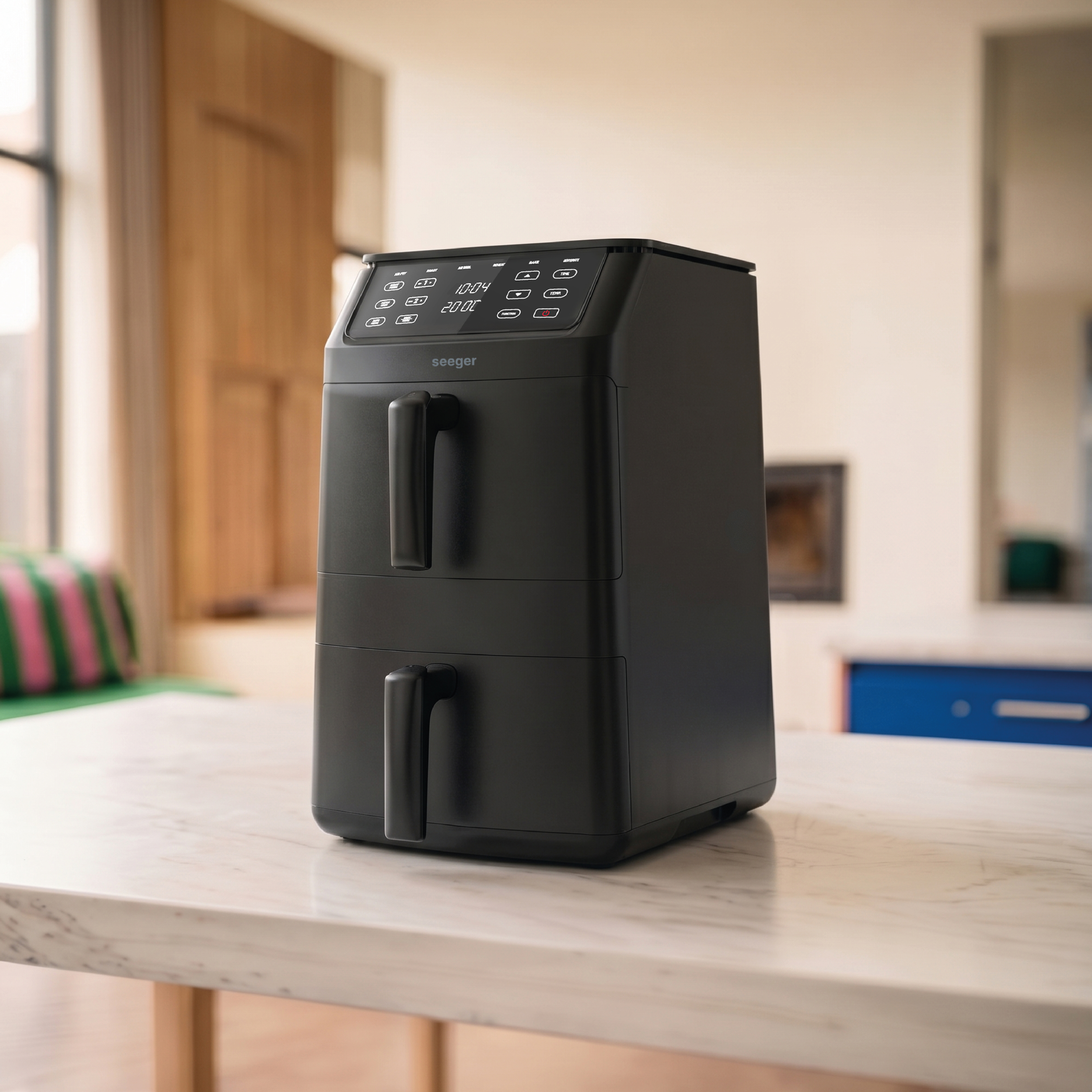 Black double-drawer air fryer on a marble table.