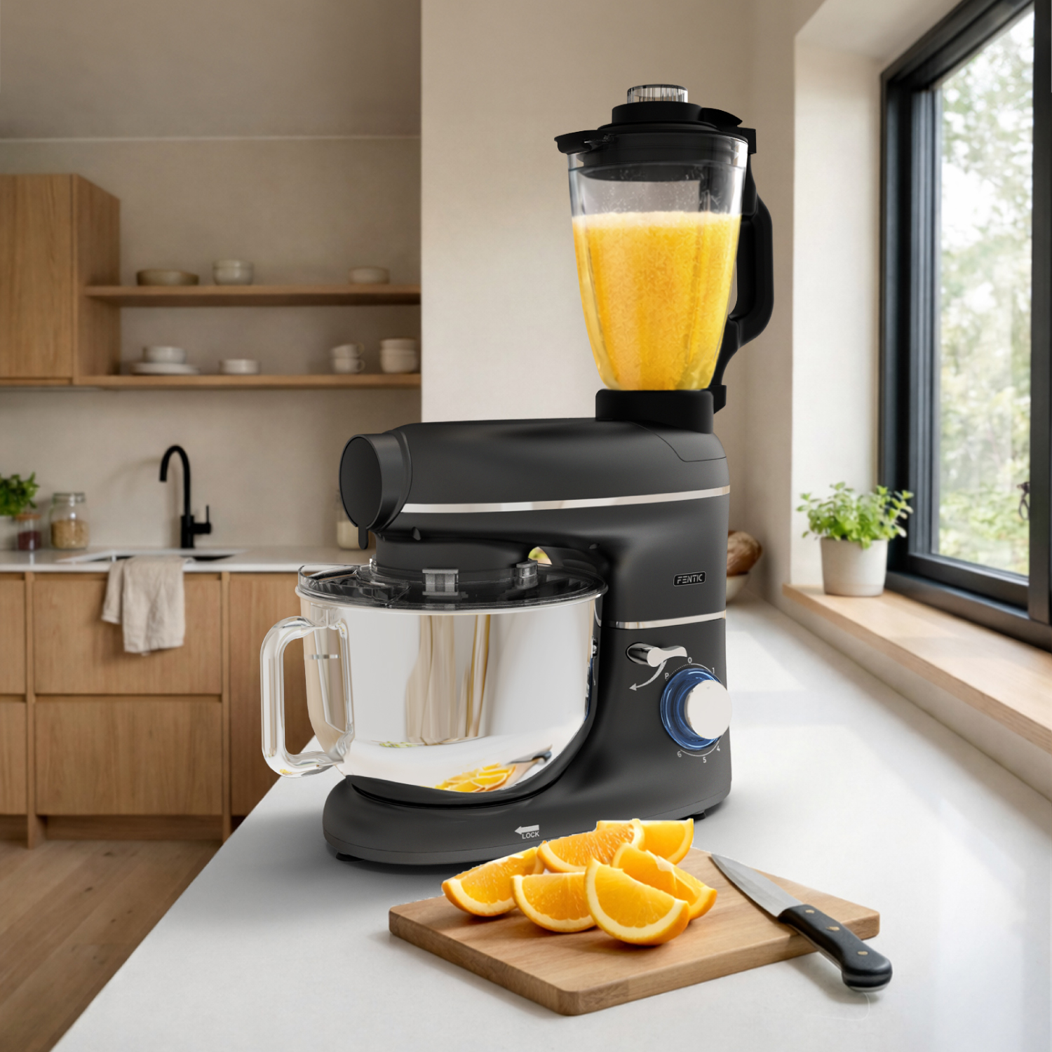 A black kitchen mixer with a blender attachment and orange slices on a cutting board.