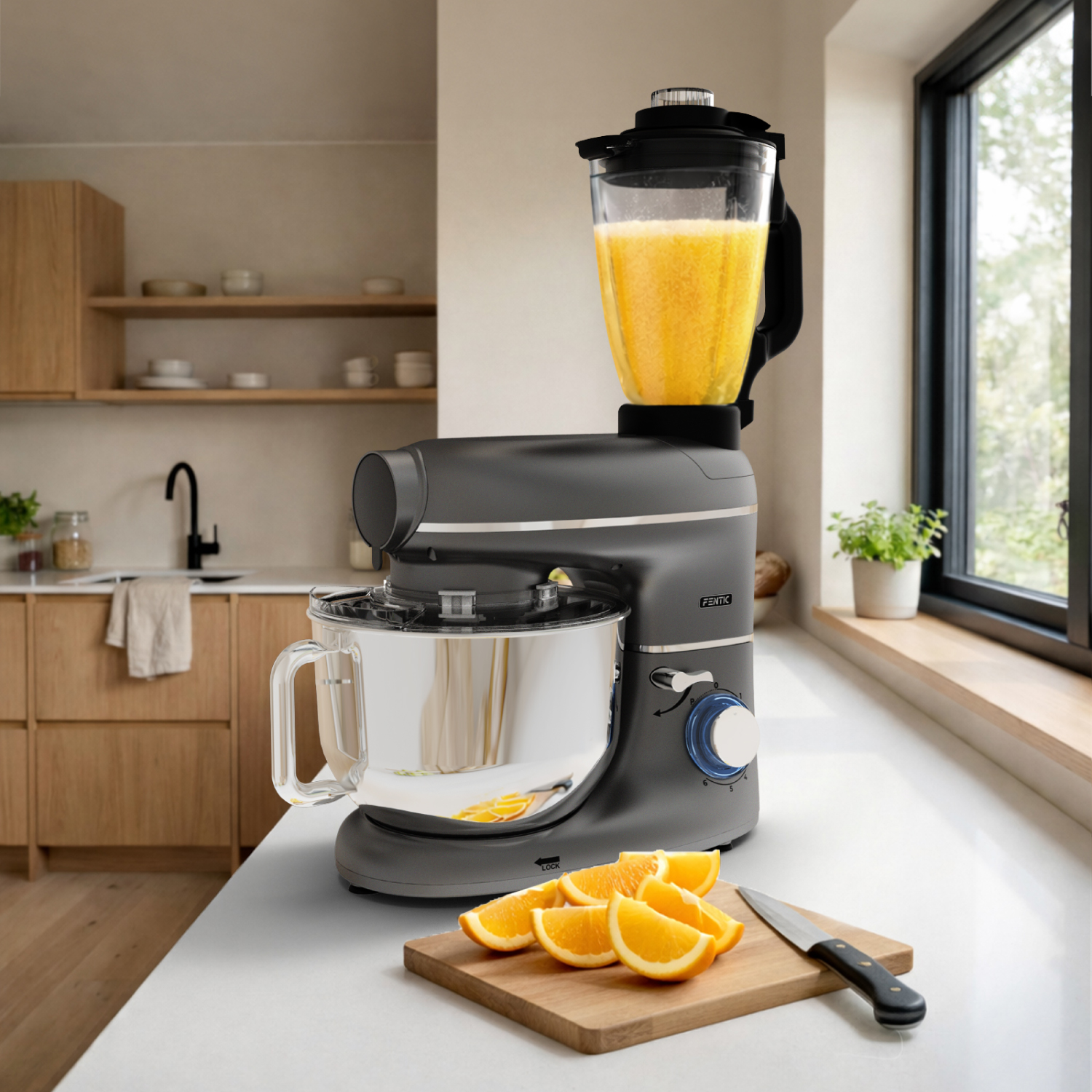 A dark grey stand mixer with a blender attachment and orange slices on a cutting board.