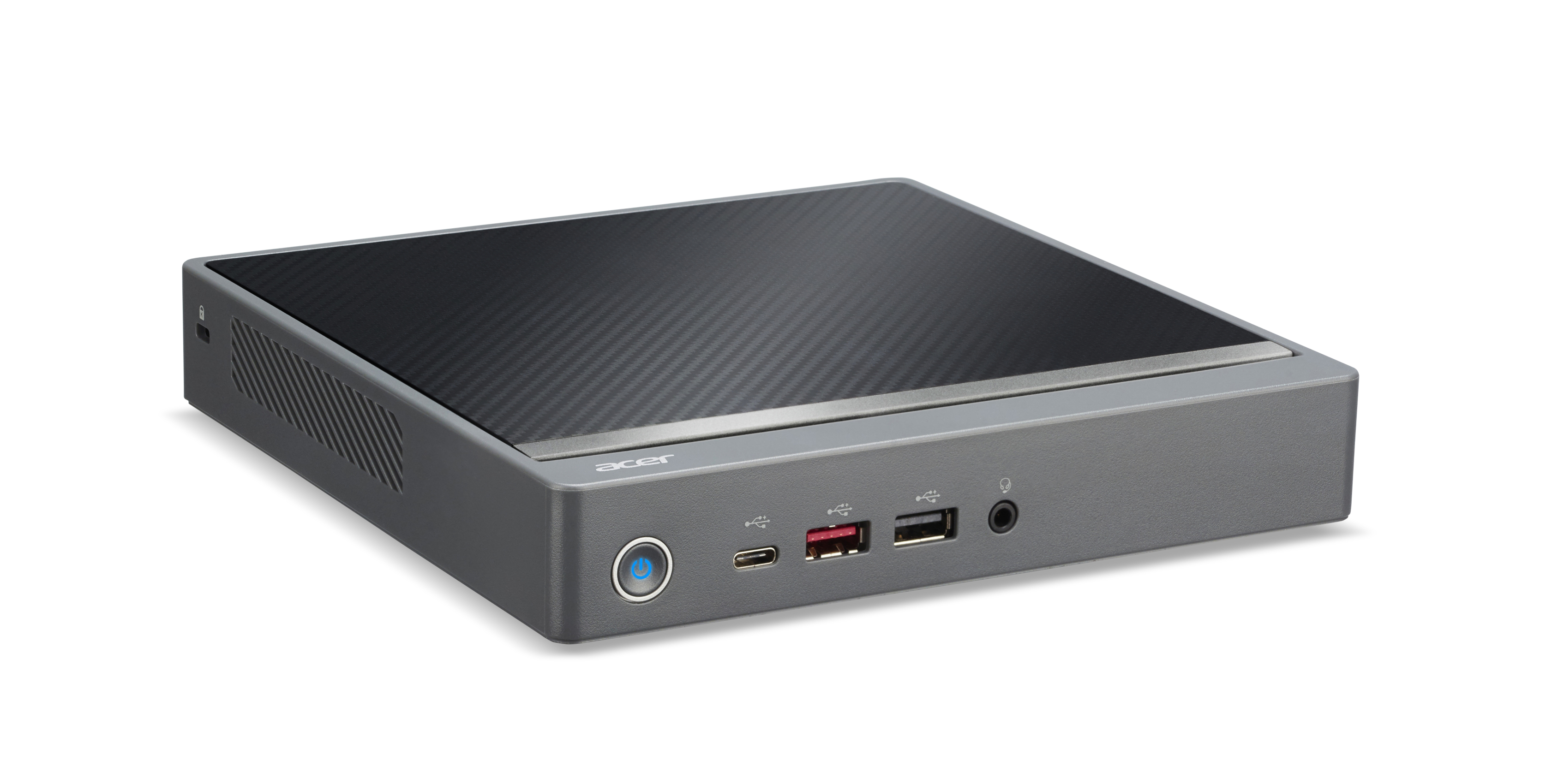 Un mini PC Acer grigio con parte superiore in fibra di carbonio e porte anteriori.