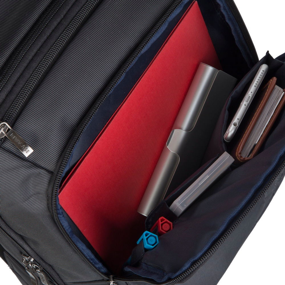 Een zwarte tas met een rode map, telefoon, notitieboekje en pennen.