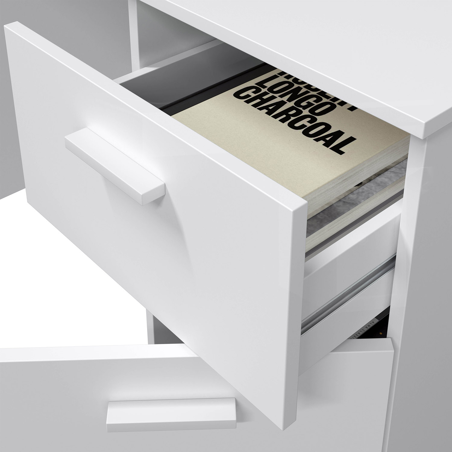 Un mueble blanco con un cajón abierto que contiene un libro. Texto del libro: LONGO CHARCOAL.