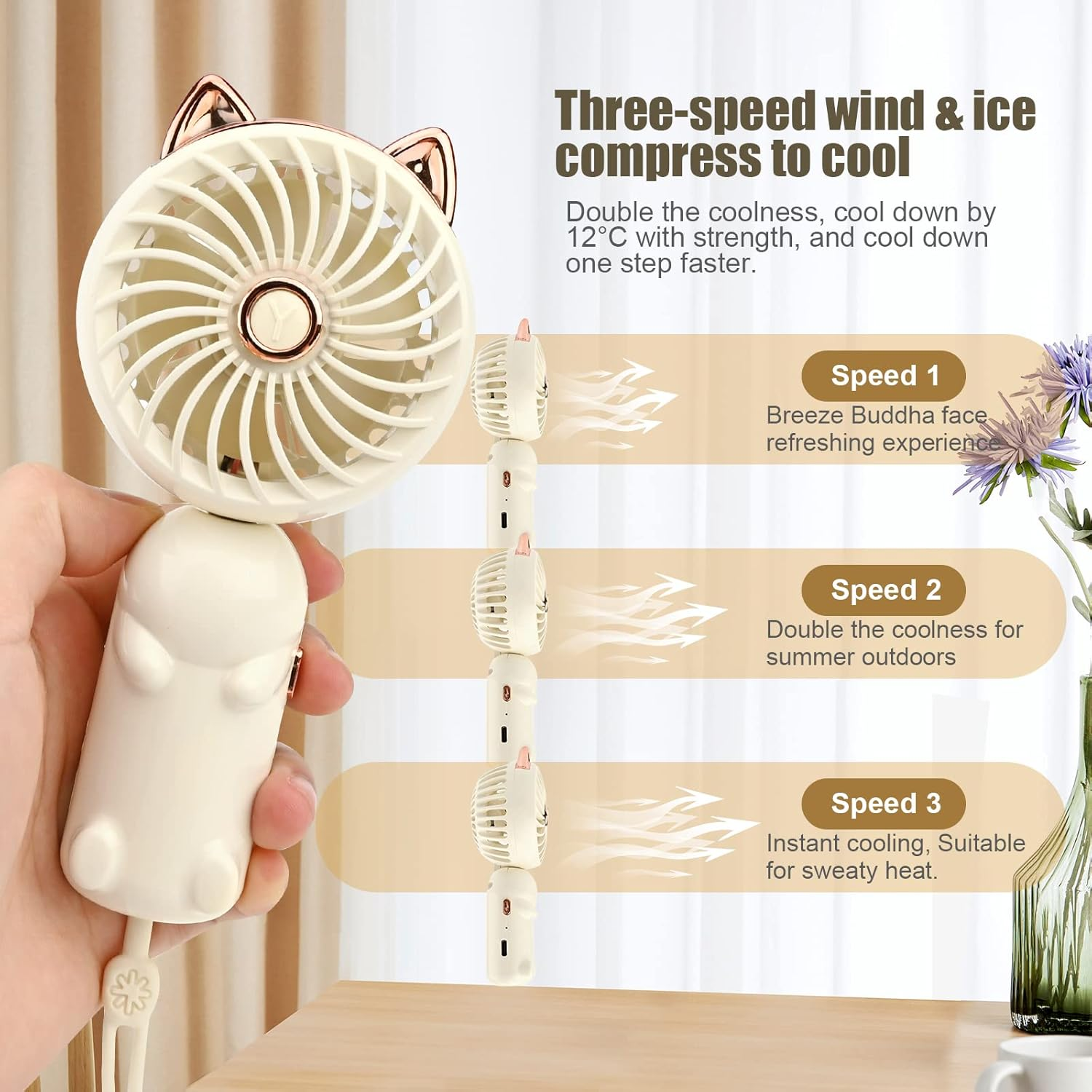 Ein handgehaltener weißer Ventilator mit Katzenohren, der drei Geschwindigkeiten anzeigt.