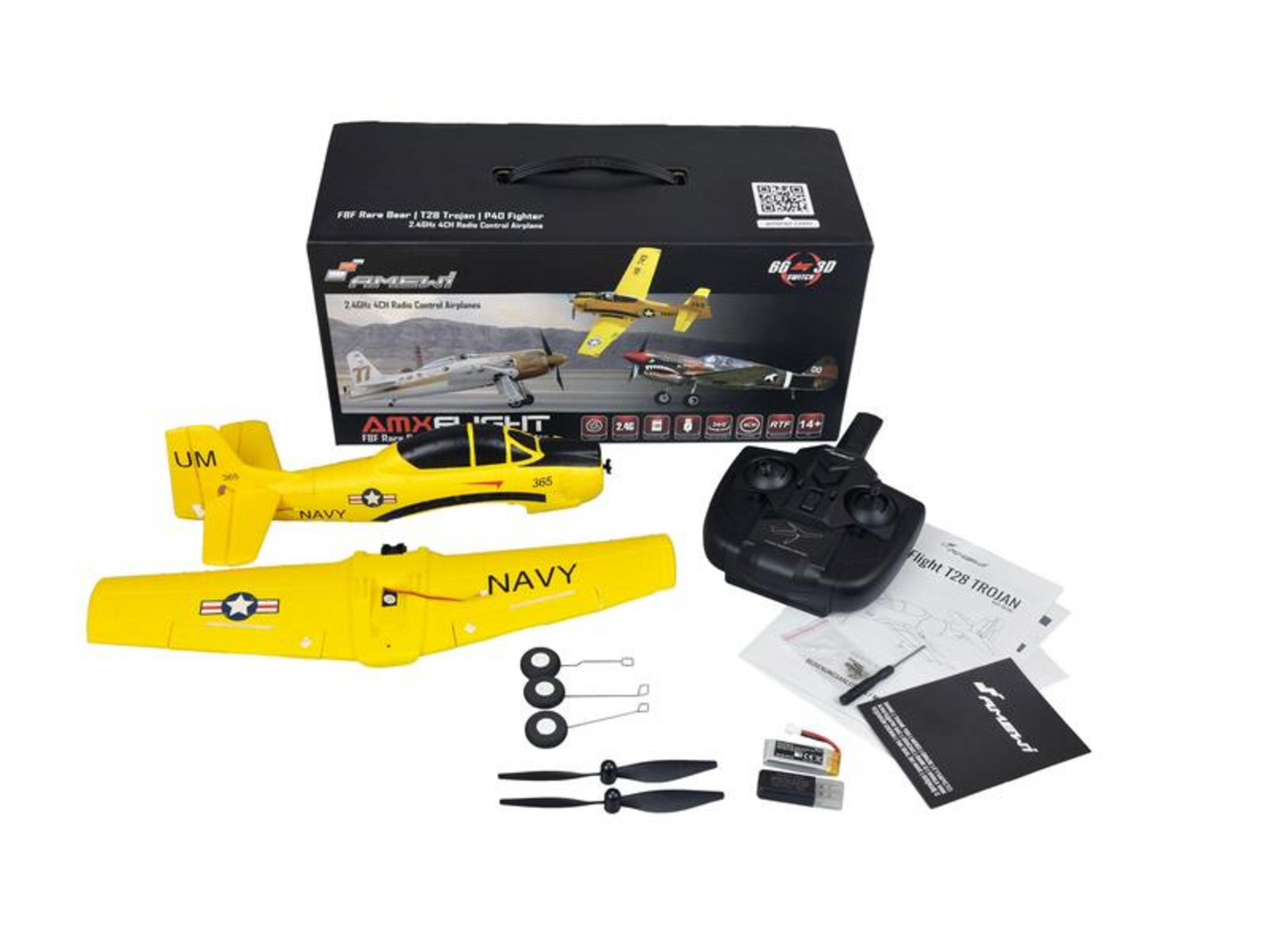 Un avión modelo amarillo con control remoto, repuestos y embalaje.