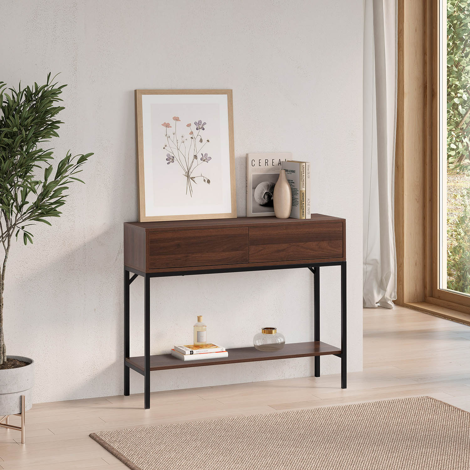 Mesa consola de madera oscura con patas negras, obra de arte, libros y planta.