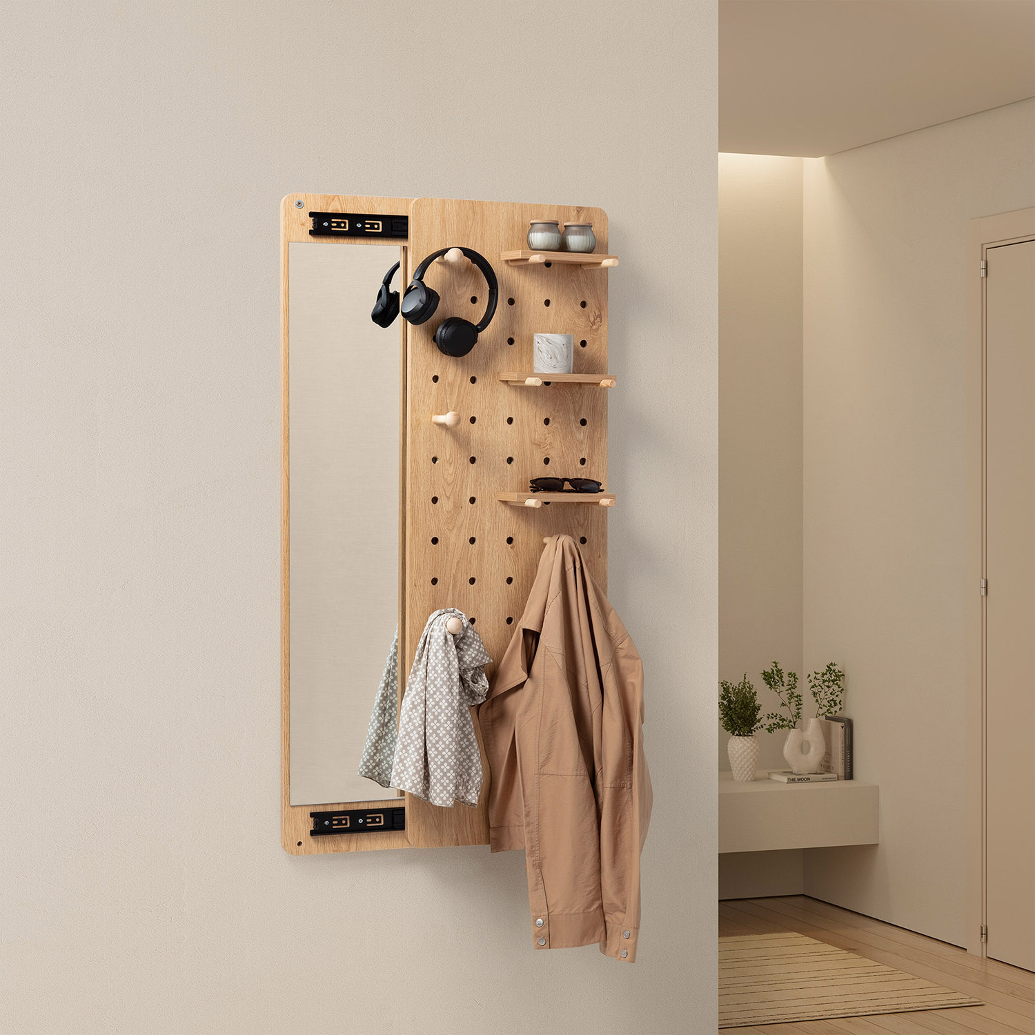 Panel de pared de madera con espejo, auriculares, chaqueta, bufanda y gafas de sol.