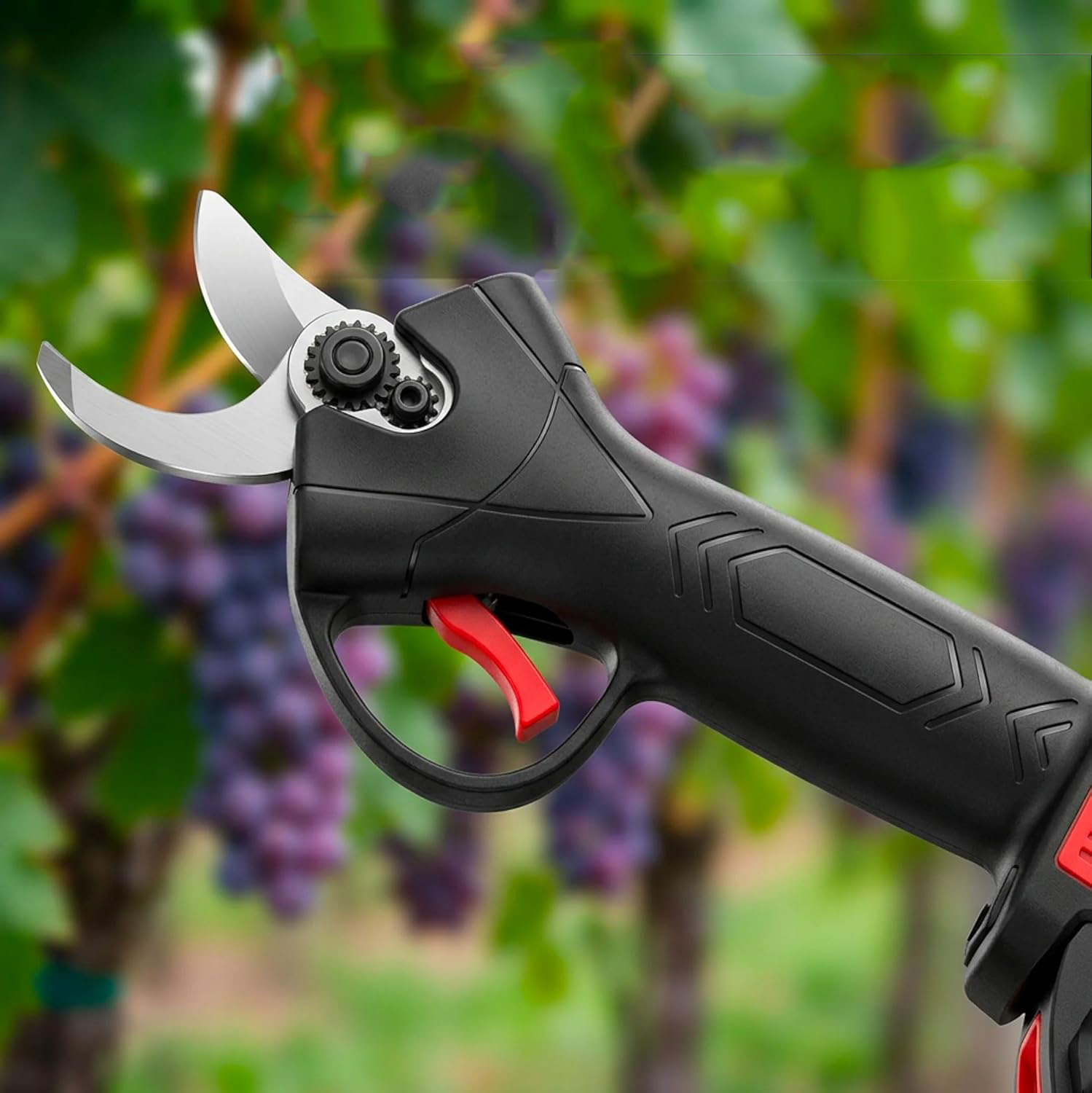 Una podadora eléctrica negra con gatillo rojo frente a vides borrosas.