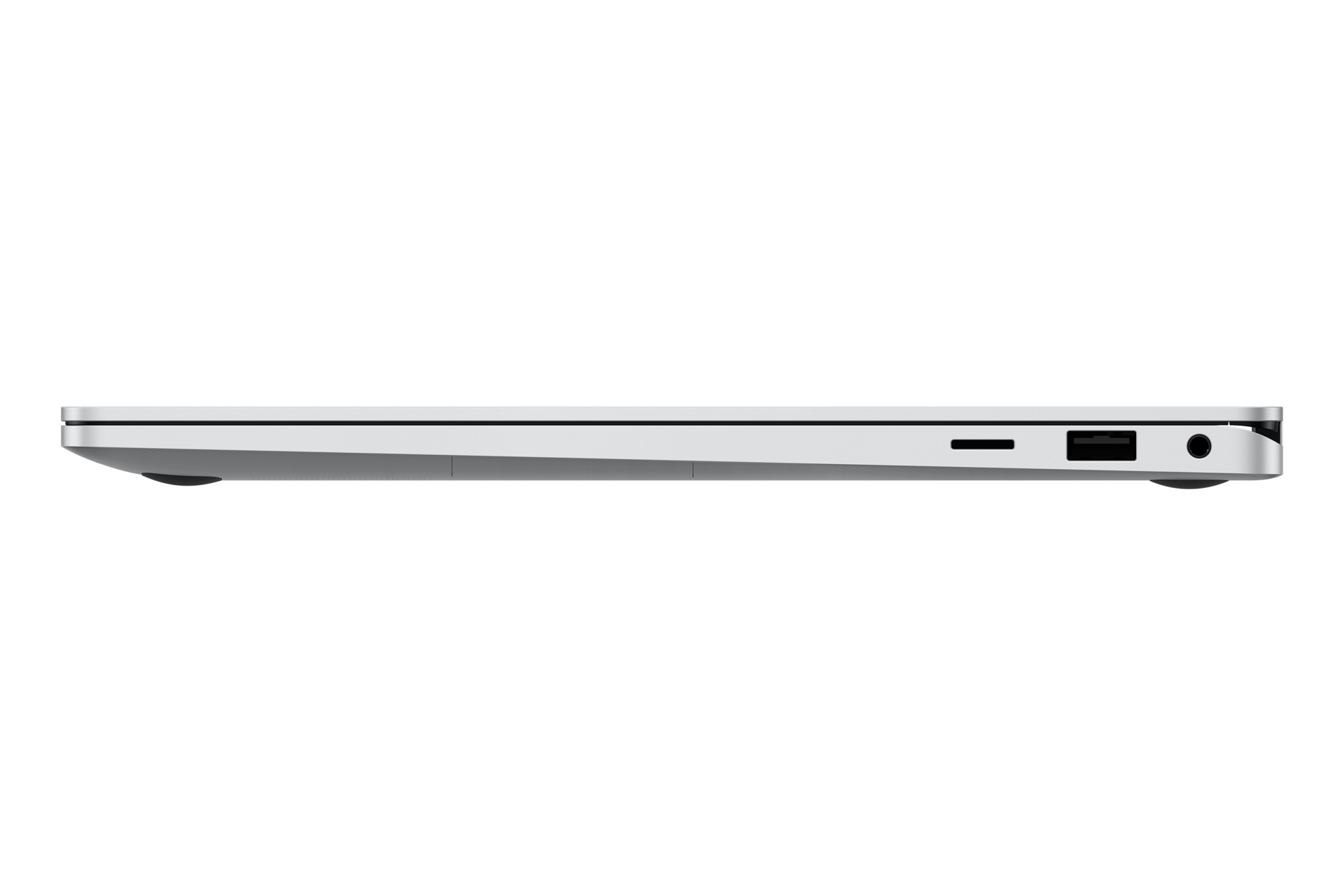 Vue latérale d'un ordinateur portable fin et argenté avec ports USB et casque.