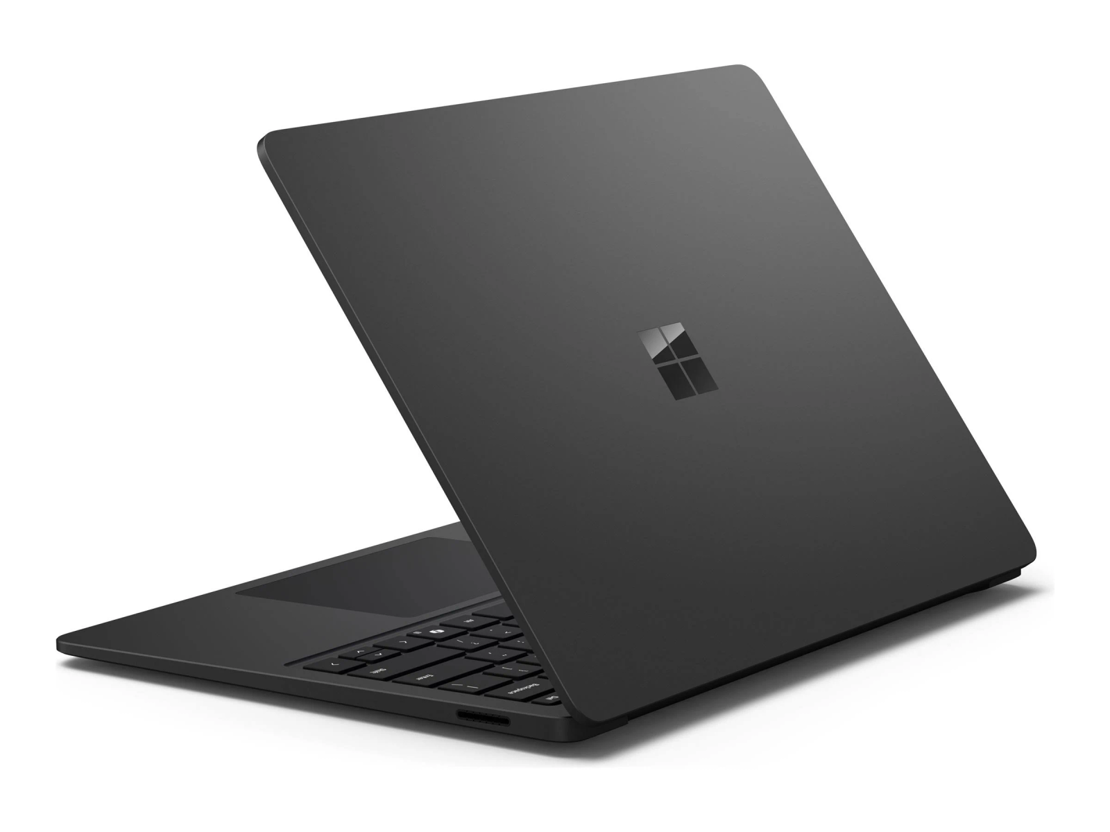 Un portátil Microsoft Surface gris oscuro está abierto, mostrando teclado y trackpad.