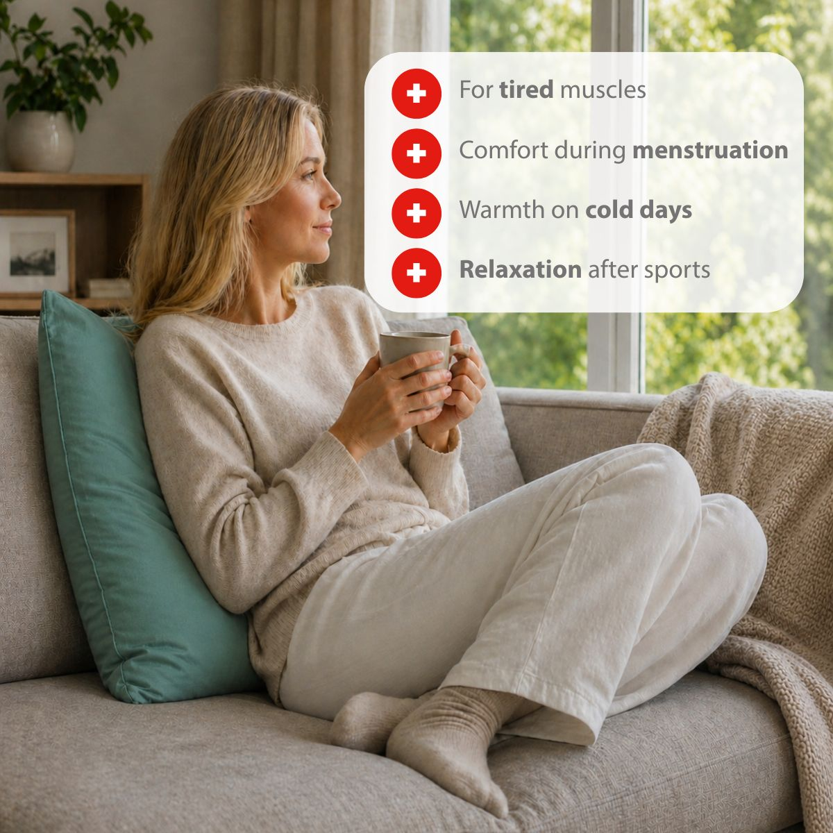 A woman sits on a sofa holding a cup, with four benefits listed on screen.