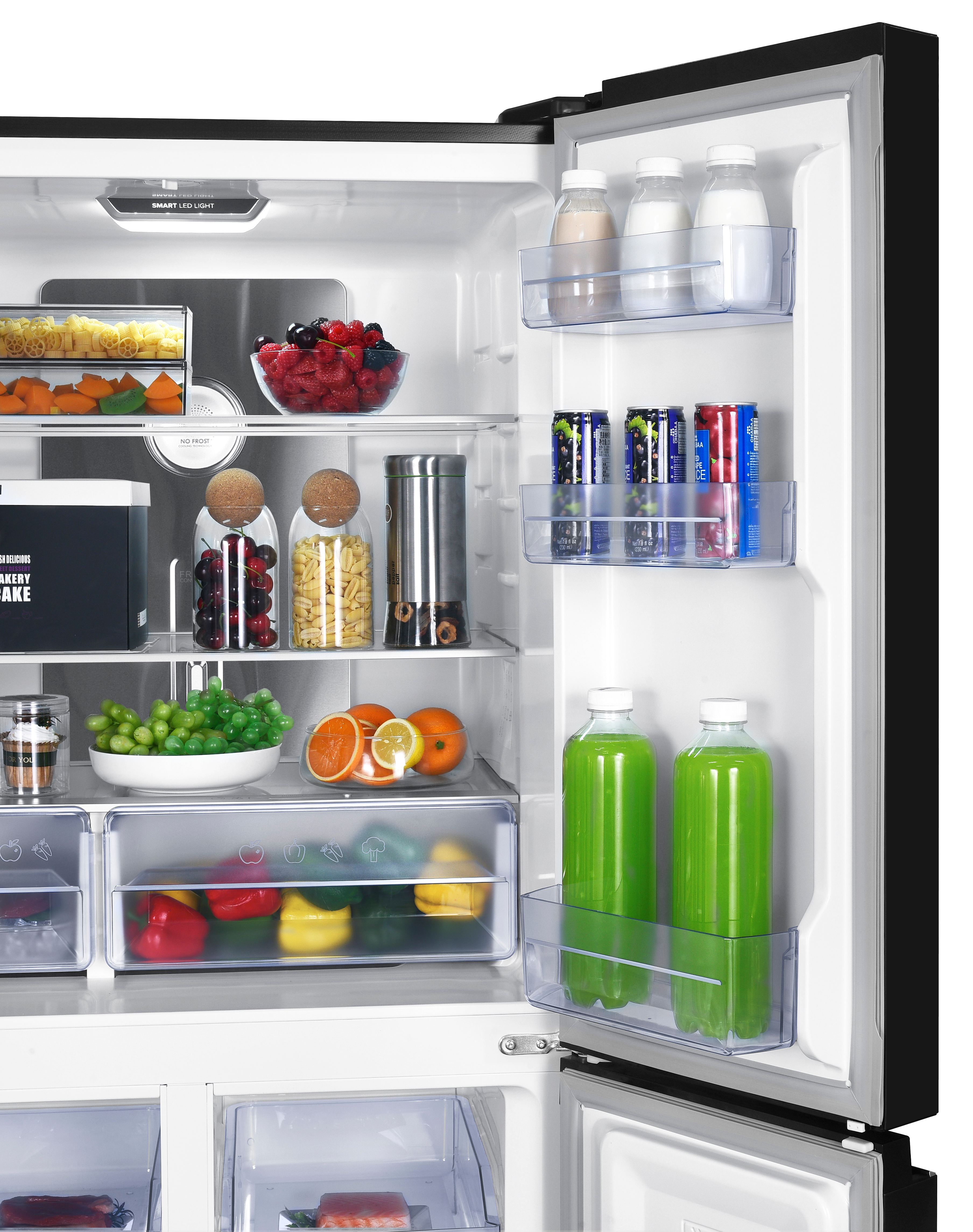 A refrigerator filled with food: fruits, vegetables, pasta, drinks, and cake.