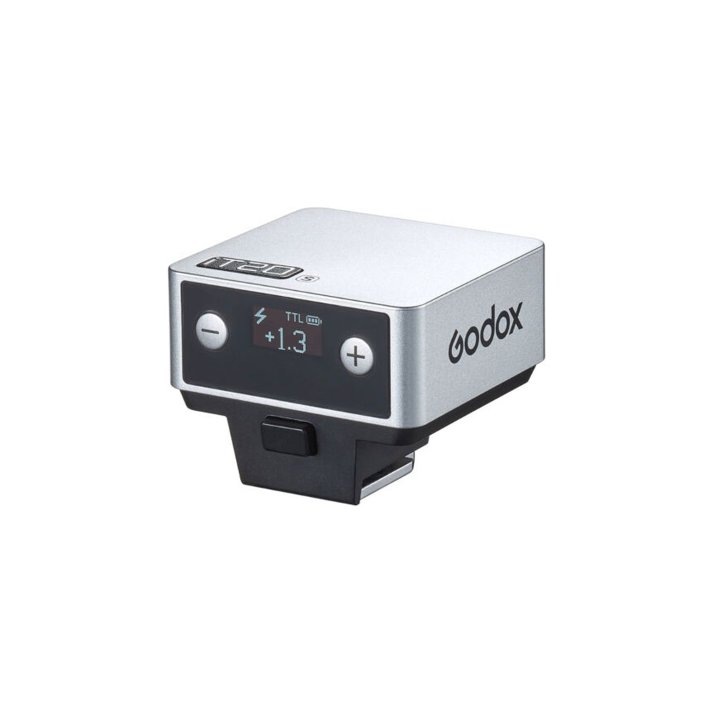 Émetteur Godox argenté avec base noire, écran numérique affichant TTL +1.3.