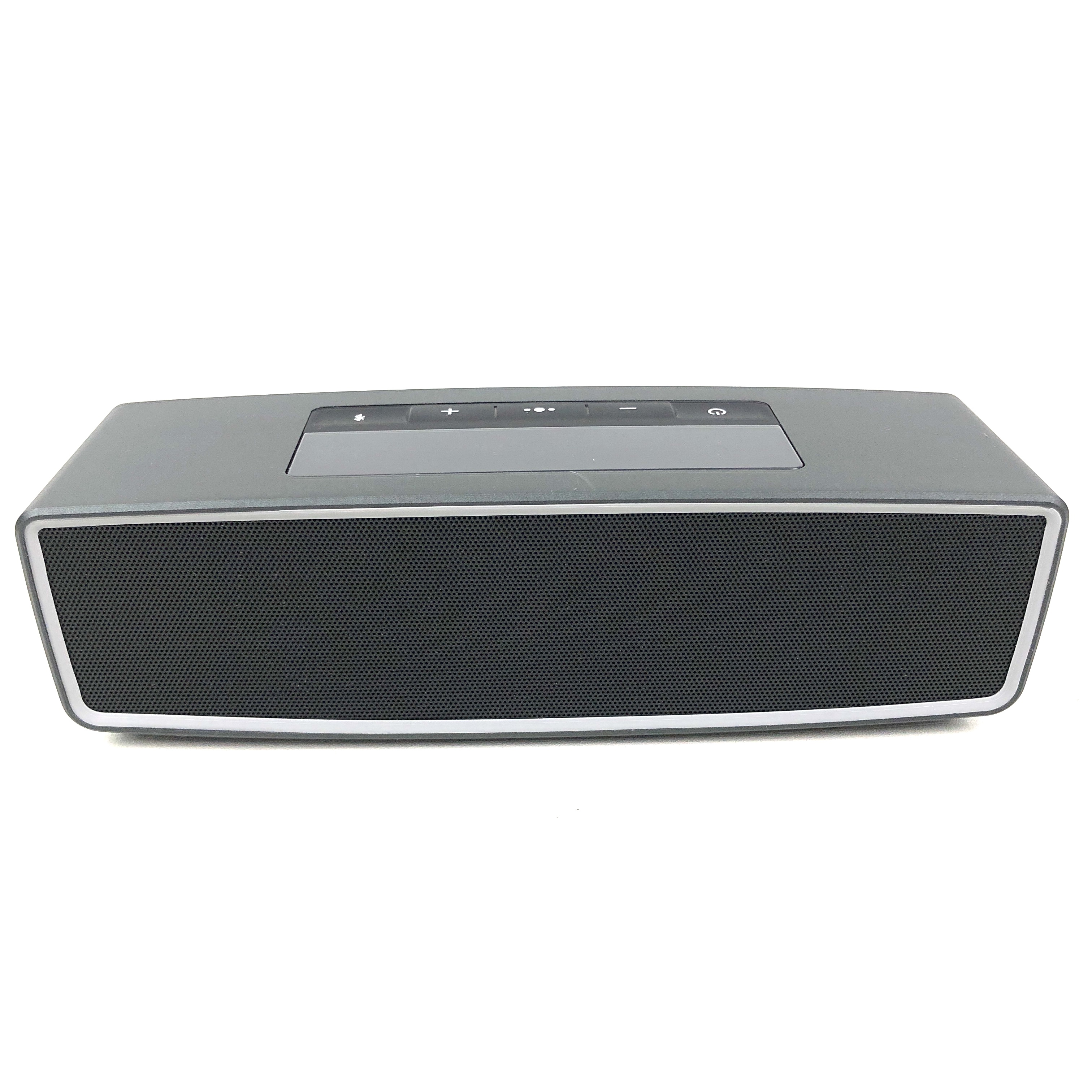 Ein grauer Bluetooth-Lautsprecher mit schwarzen Lautsprechergittern und Bedienelementen.
