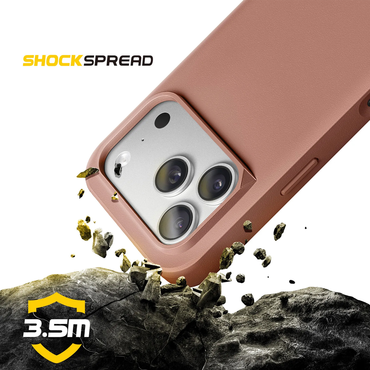 Una custodia per telefono color oro rosa cade su rocce, ma non le rompe.