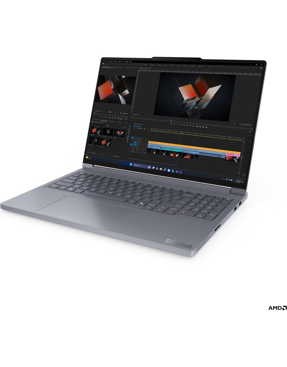 Gri dizüstü bilgisayar, ekranda geometrik şekillerle video düzenleme yazılımı gösteriyor. AMD logosu görünüyor.