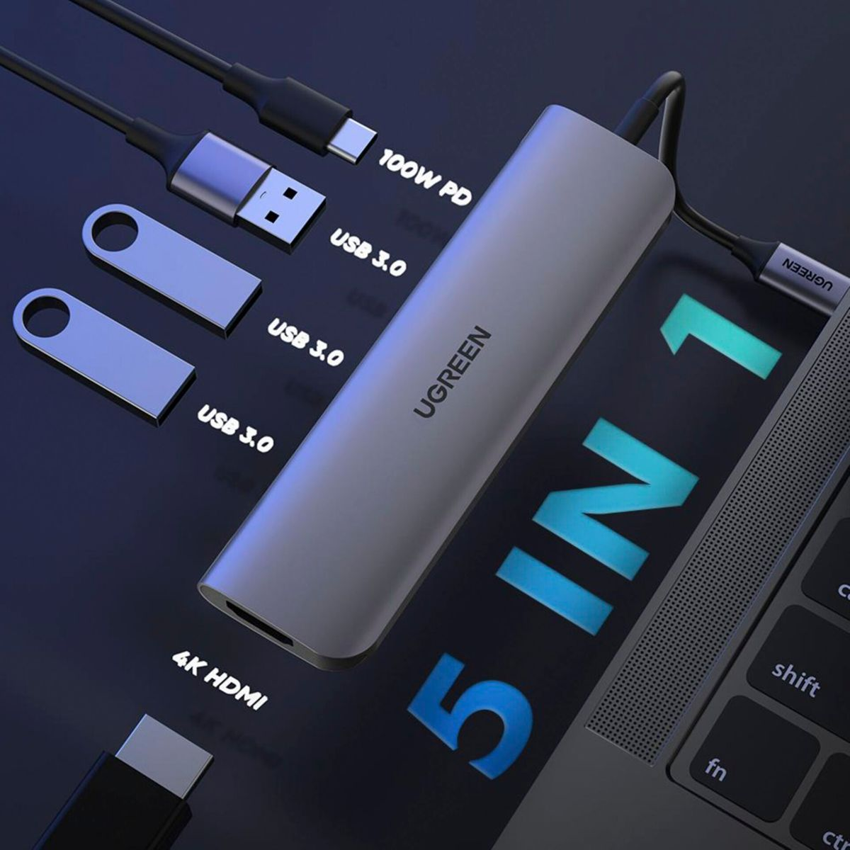 Gray 5-in-1 USB-C hub with USB drives, cables, and laptop keyboard.