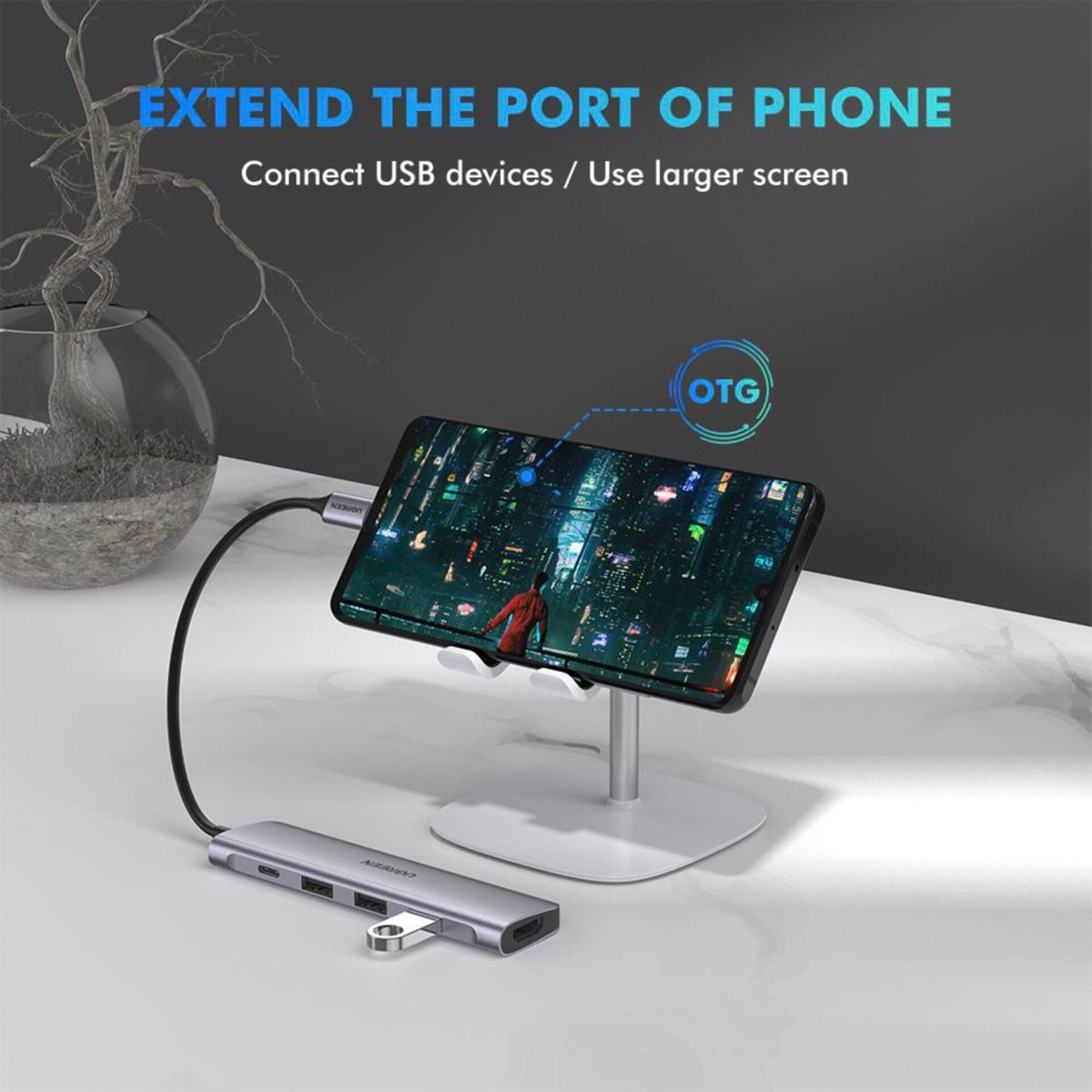 A smartphone is connected via a USB hub with OTG function.