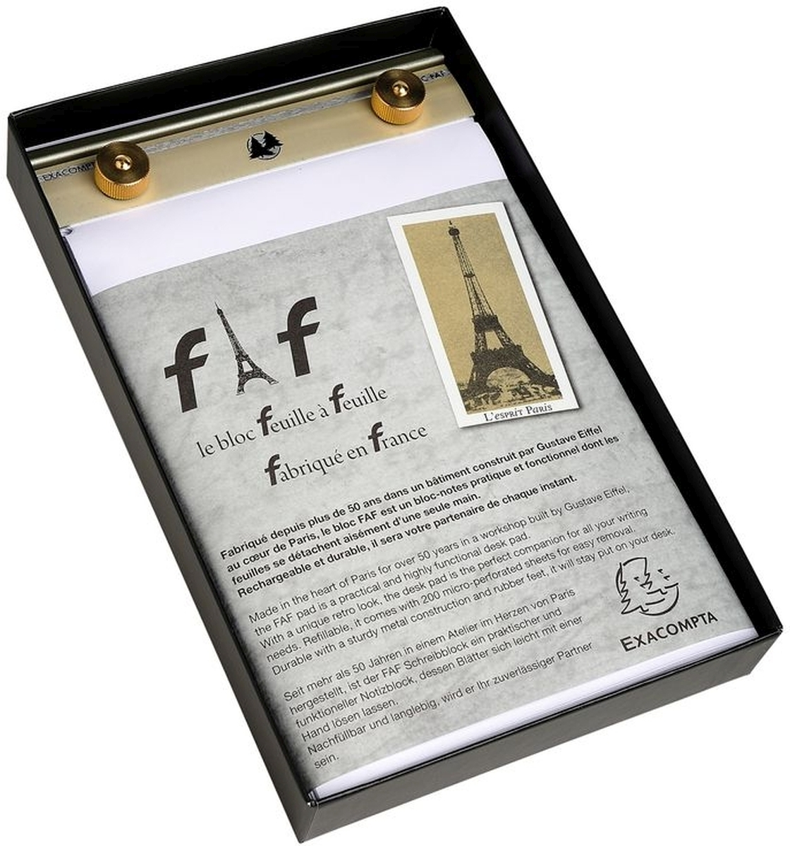 Un taccuino con motivo Torre Eiffel e clip dorate, su sfondo grigio.