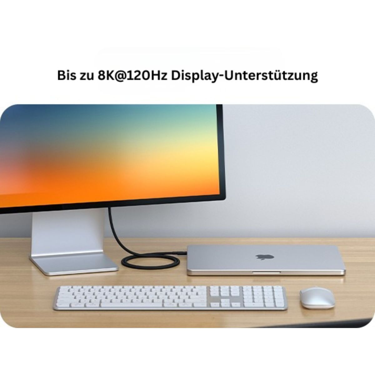 Un monitor, tastiera e mouse sono su una scrivania di legno.