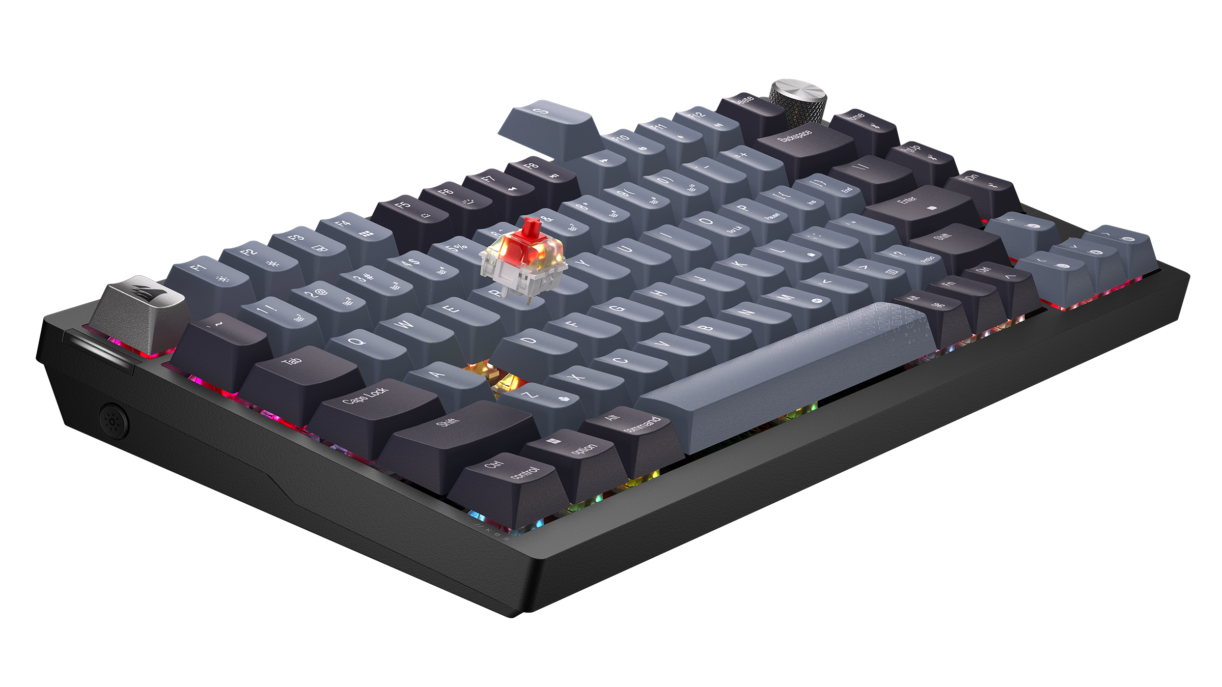 A dark mechanical keyboard with gray and black keys, an exposed red switch.