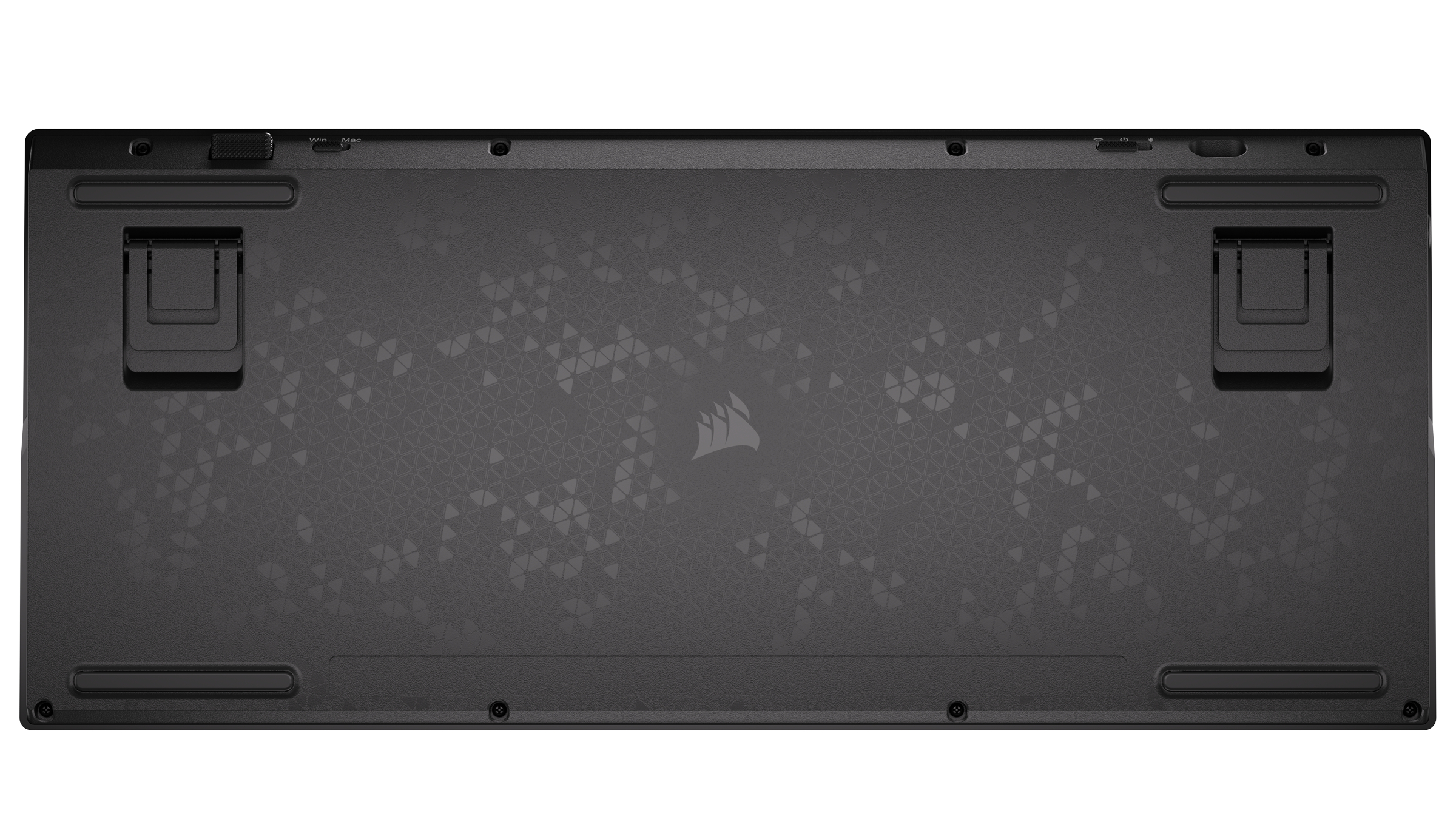 Underside of a black keyboard with textured pattern and rubber feet.