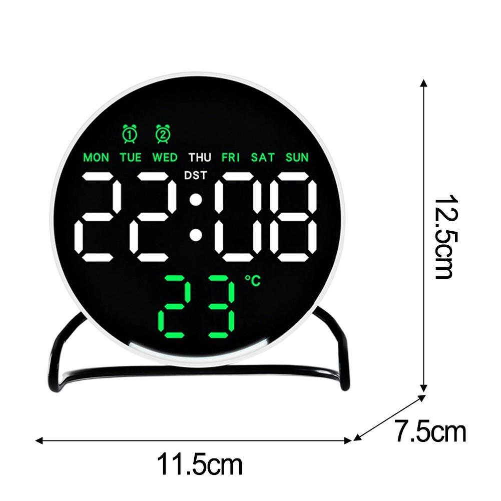 Yuvarlak siyah dijital saat 22:08 ve 23°C gösteriyor, hafta günü ile.