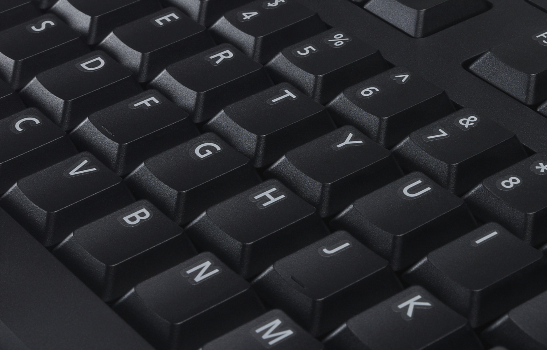 Close-up of a black keyboard. Keys visible: S, D, C, V, B, N, M, E, F, G, H, J, K, T, R, Y, U, I, 4, 5, 6, 7, 8.