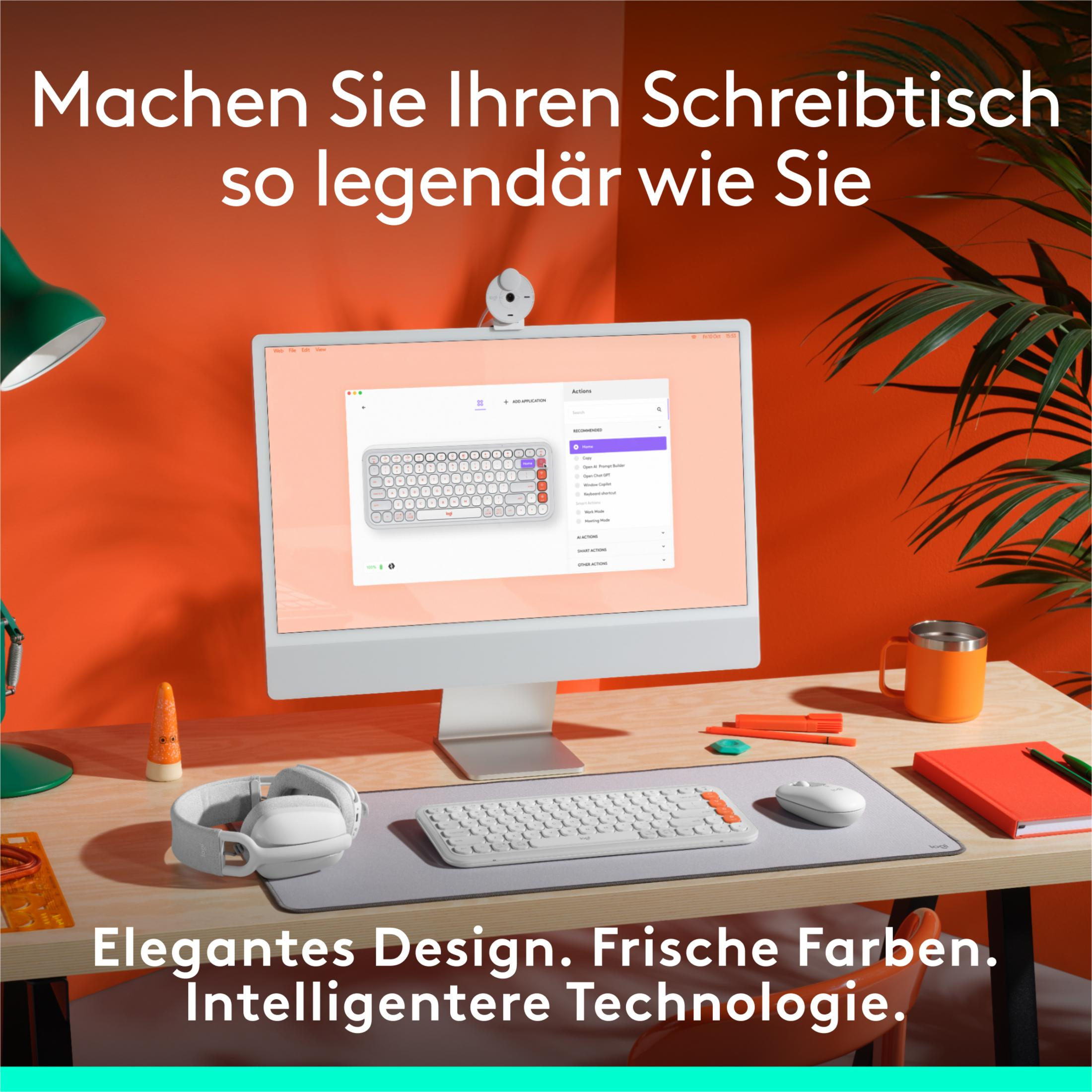 Nowoczesne stanowisko biurkowe z komputerem, klawiaturą, myszką i słuchawkami.