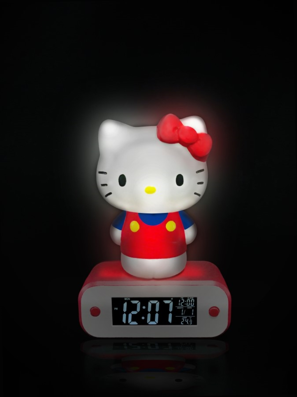 Podświetlany budzik Hello Kitty z czerwoną kokardką, czerwoną sukienką i cyfrowym wyświetlaczem.