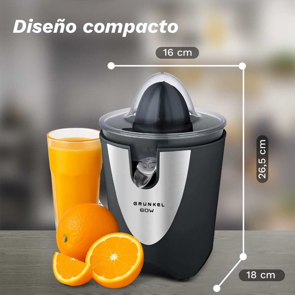 Un exprimidor compacto con naranjas y un vaso de zumo.