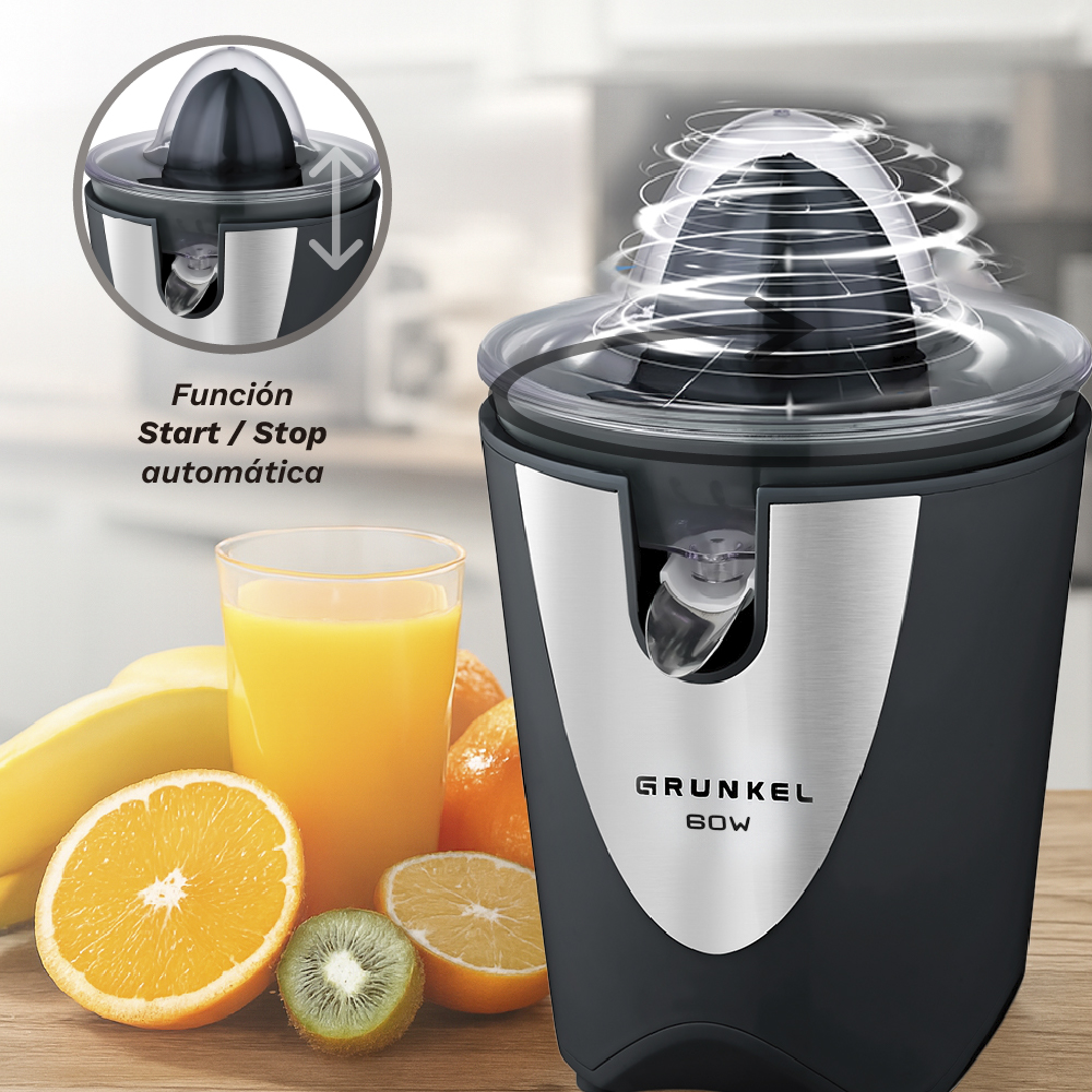 Un exprimidor eléctrico de cítricos con fruta al lado.