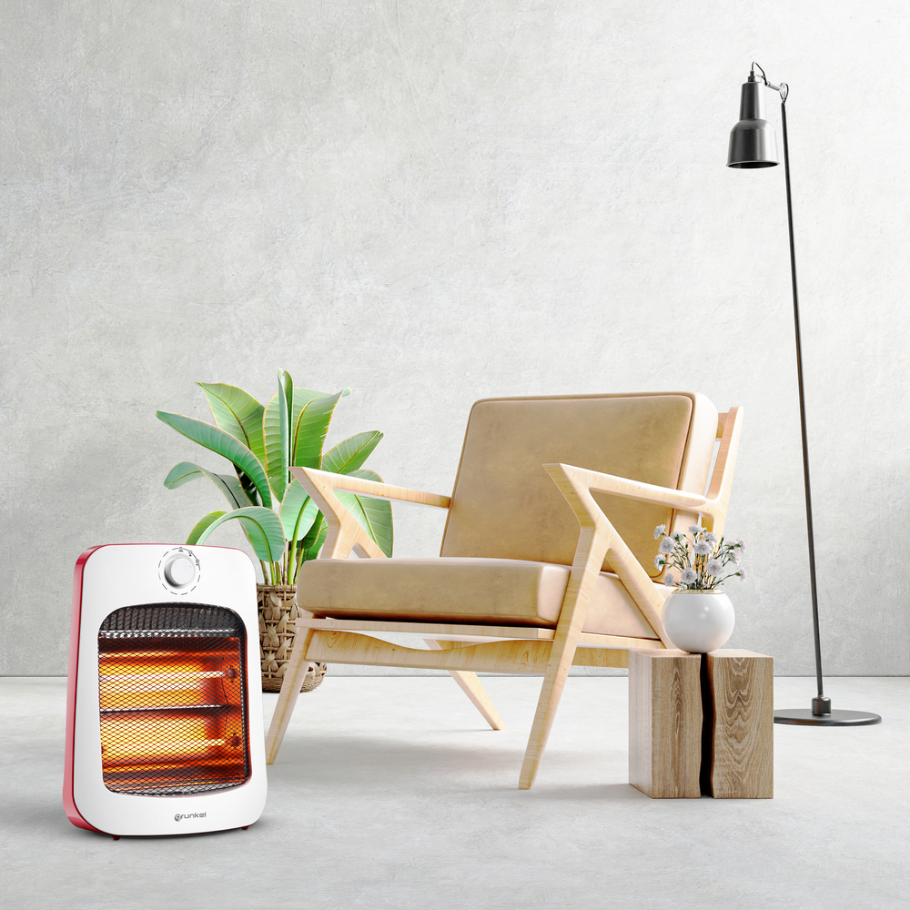Un calefactor junto a sillón, planta y mesita auxiliar con lámpara.