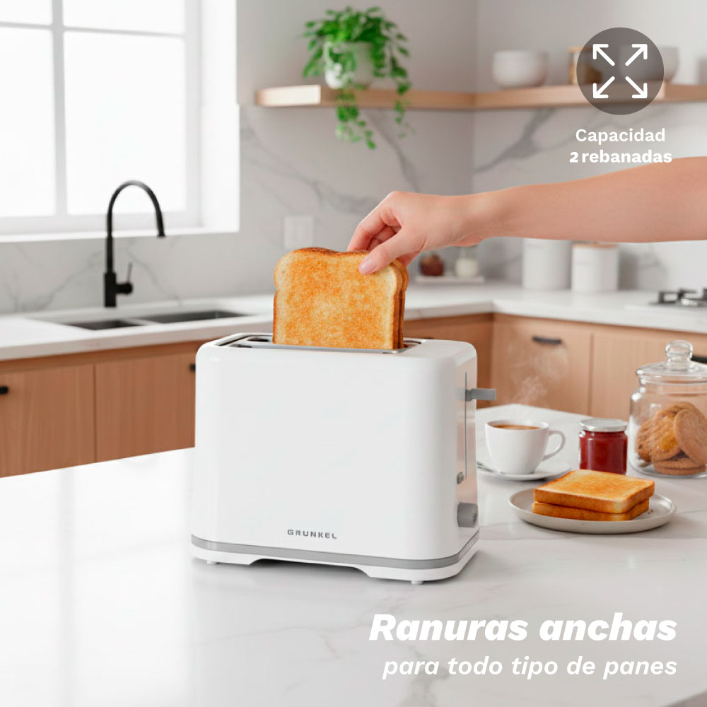Eine Hand steckt Toast in einen weißen Toaster in einer Küche.
