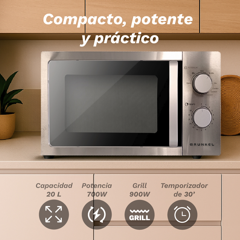 Un horno de microondas plateado con perillas y temporizador, sobre una encimera.