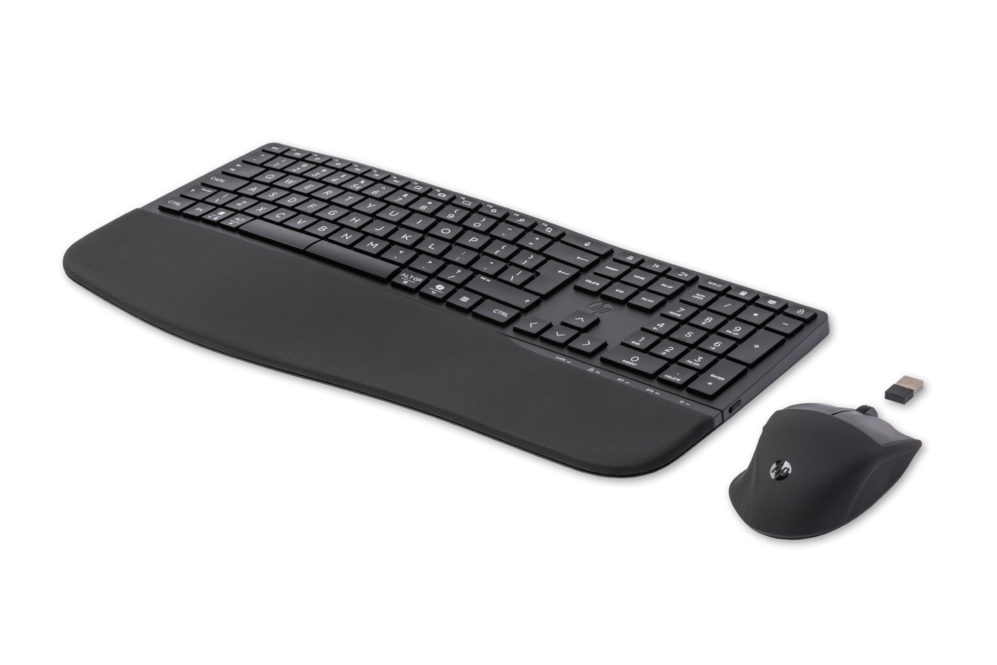 Black keyboard with wrist rest and mouse beside it, with USB dongle.