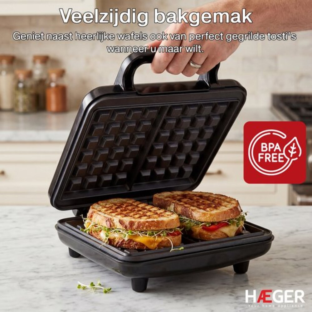 An open sandwich maker with two grilled sandwiches inside.