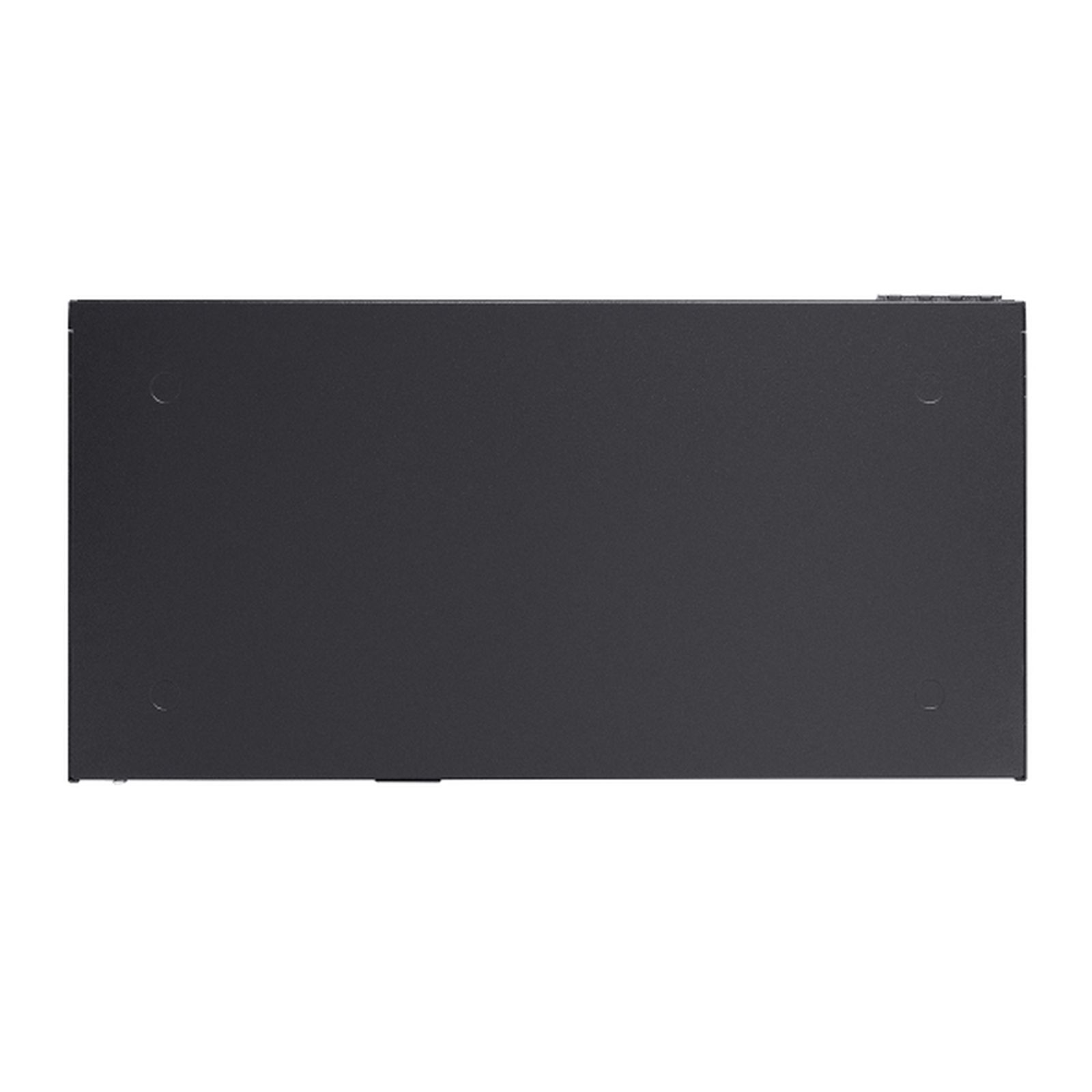 Un appareil rectangulaire sombre avec quatre pieds ronds et un bord supérieur visible.