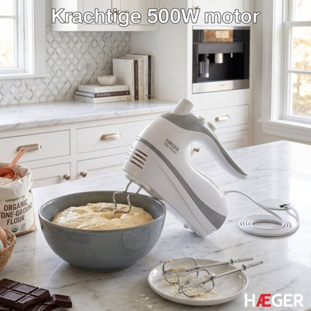 A white and grey hand mixer is mixing dough in a grey bowl.