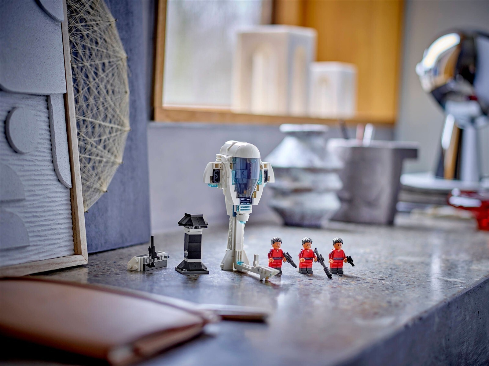 Lego-Raumschiff mit drei Figuren auf einem Steintisch.