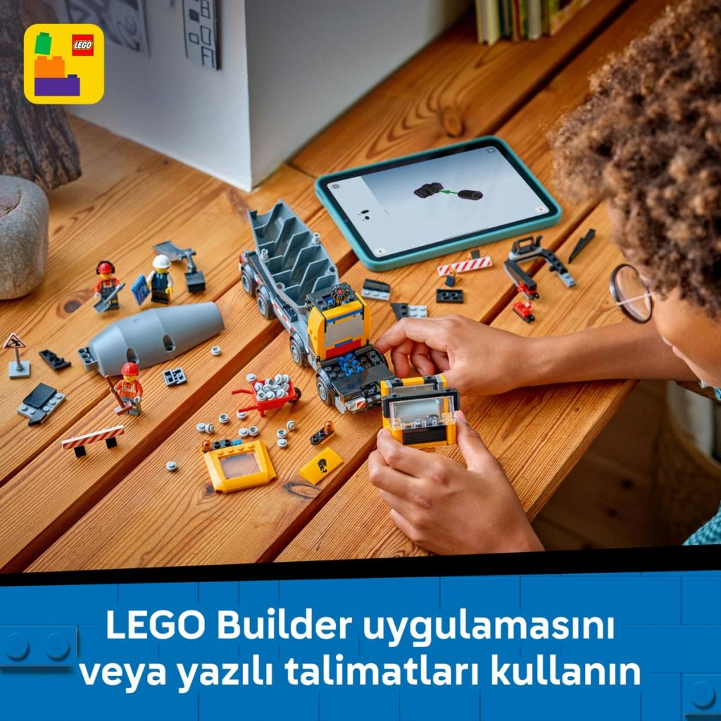 Dziecko buduje ciężarówkę LEGO z instrukcjami na tablecie.