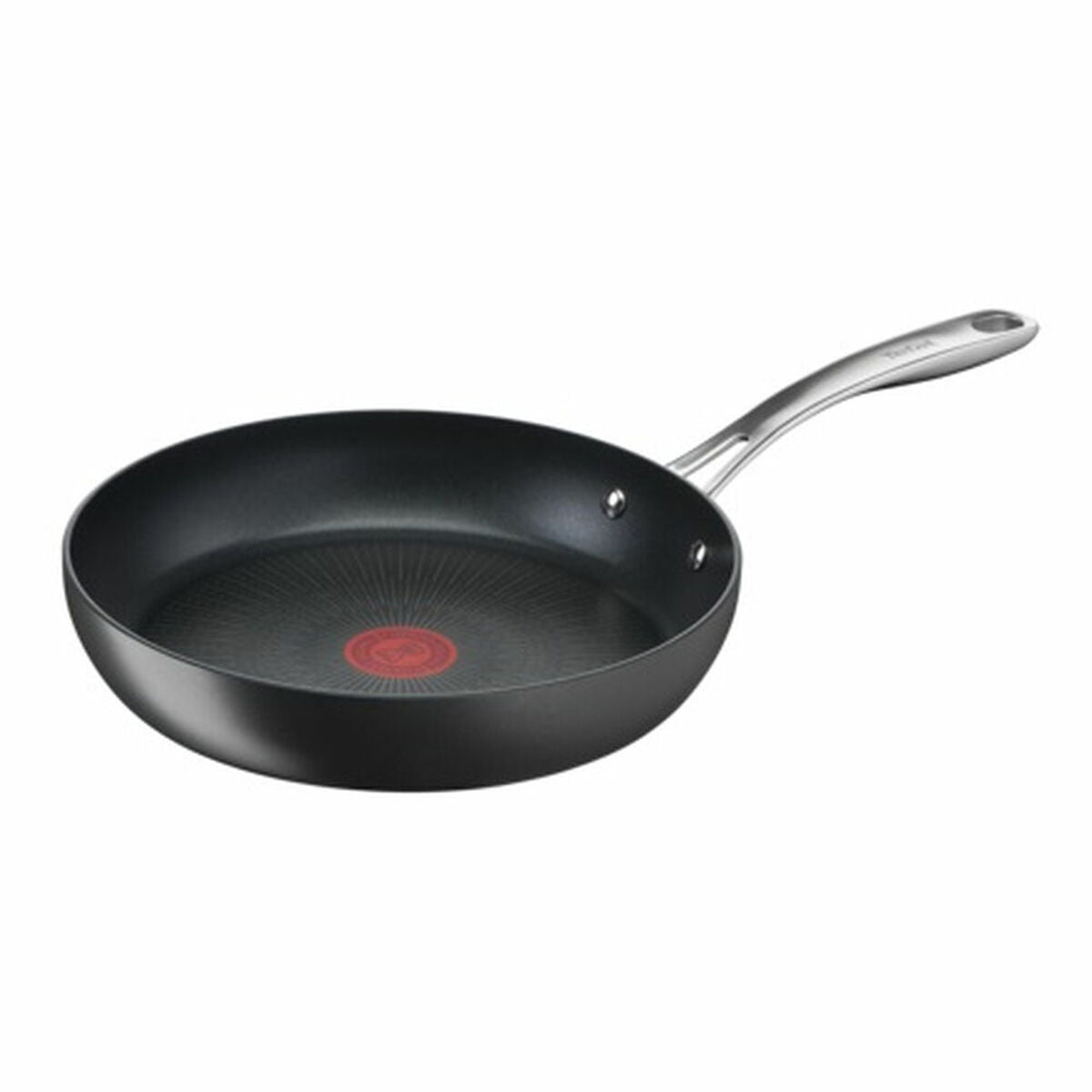 Sartén negra con mango plateado y punto rojo de calor en el centro.