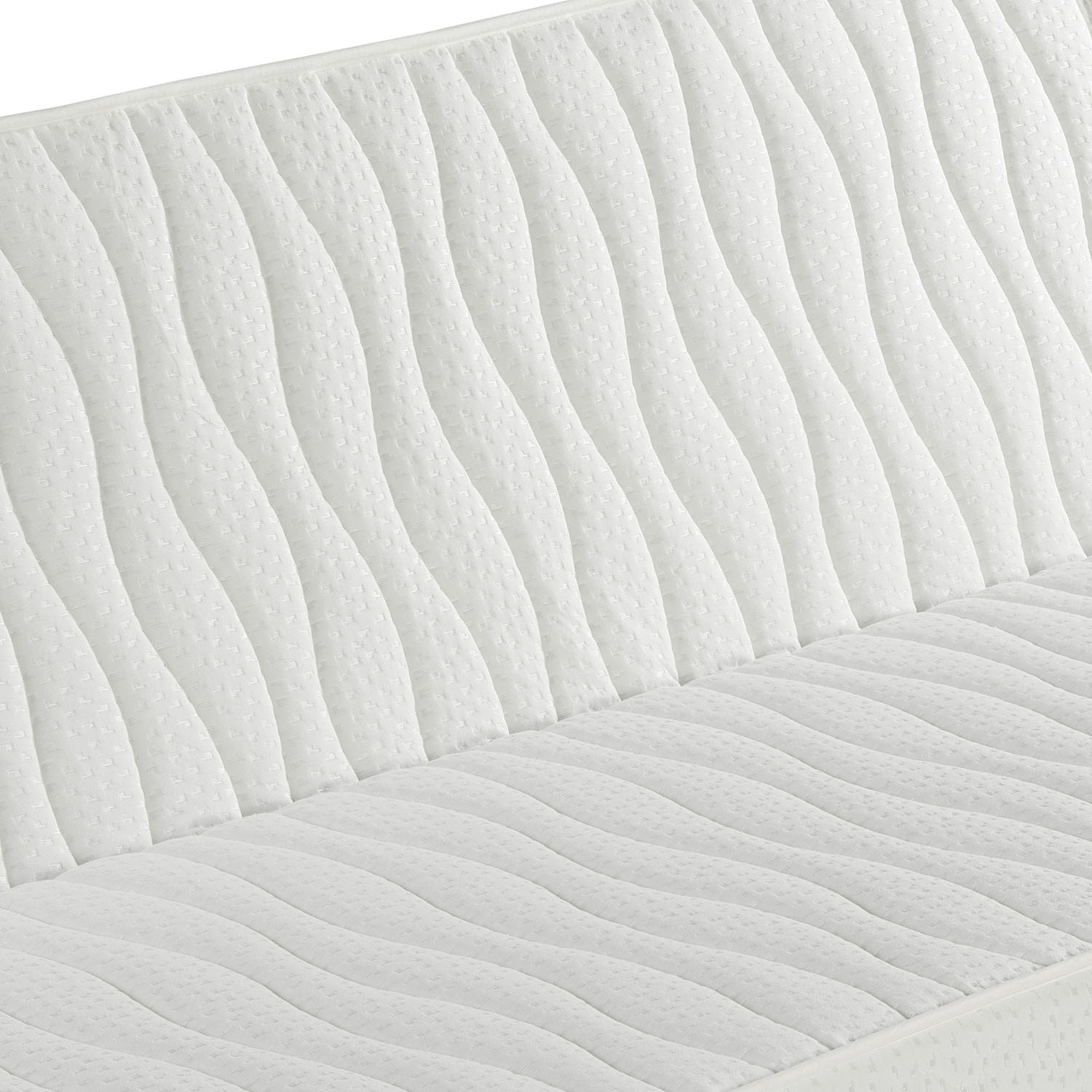 Un colchón blanco con acolchado ondulado. Primer plano.