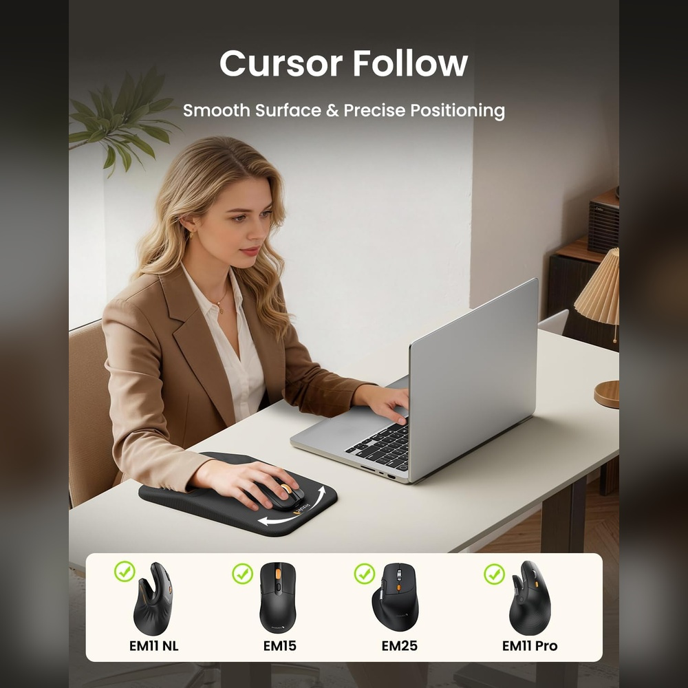 Woman at desk using a laptop, with a mouse on a mousepad beside it.