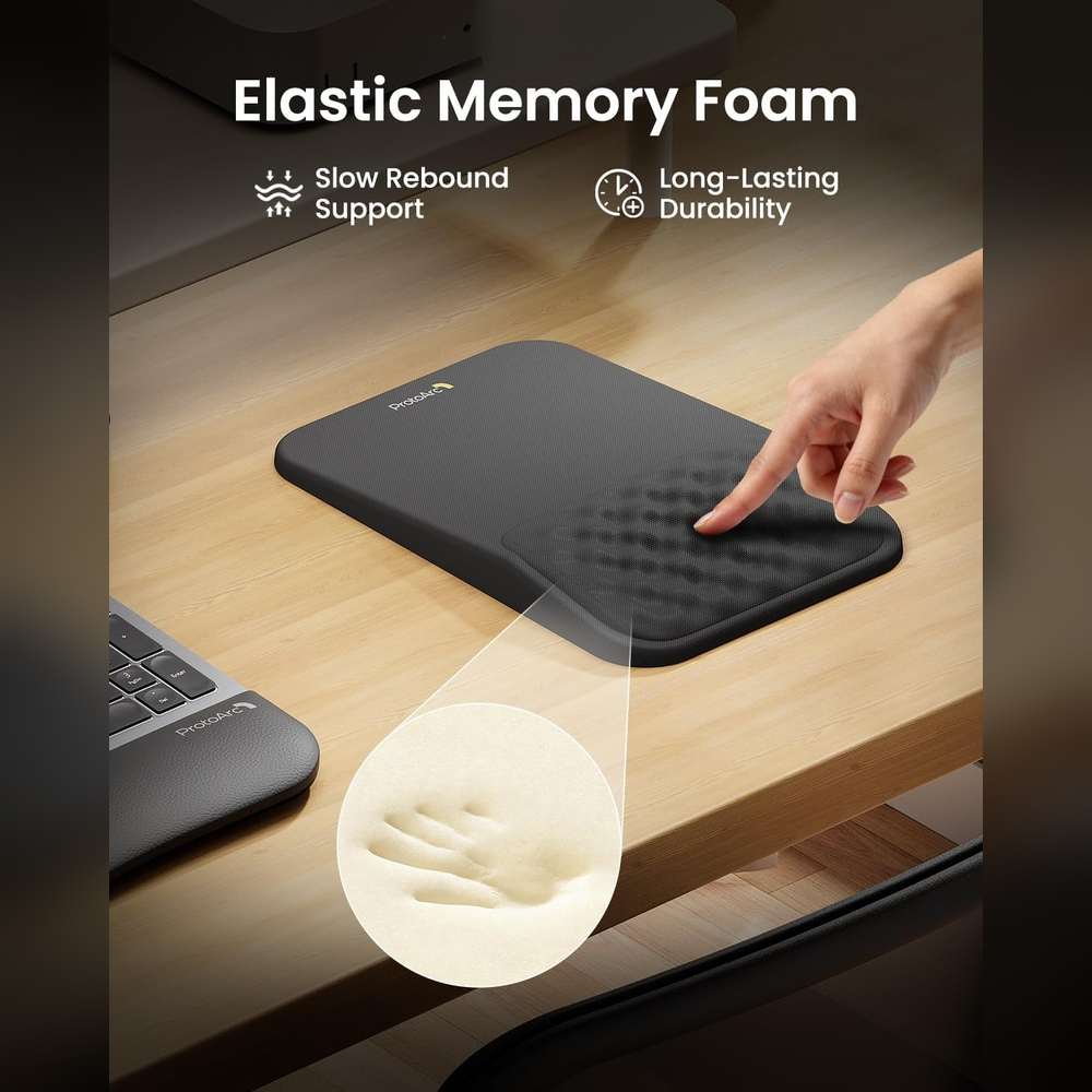 Hand presses on black mouse pad with memory foam. See detail view.