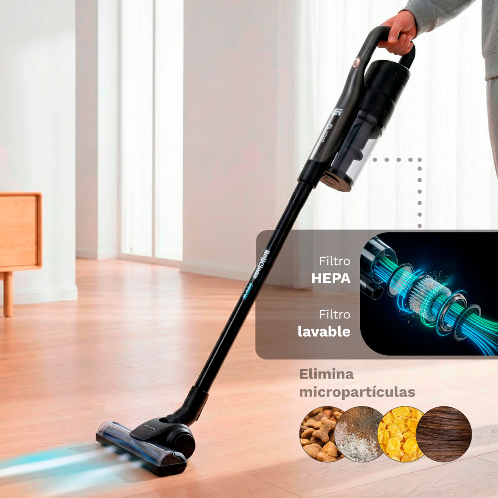 Una persona sostiene una aspiradora inalámbrica negra sobre suelo de madera. Primer plano filtro HEPA.