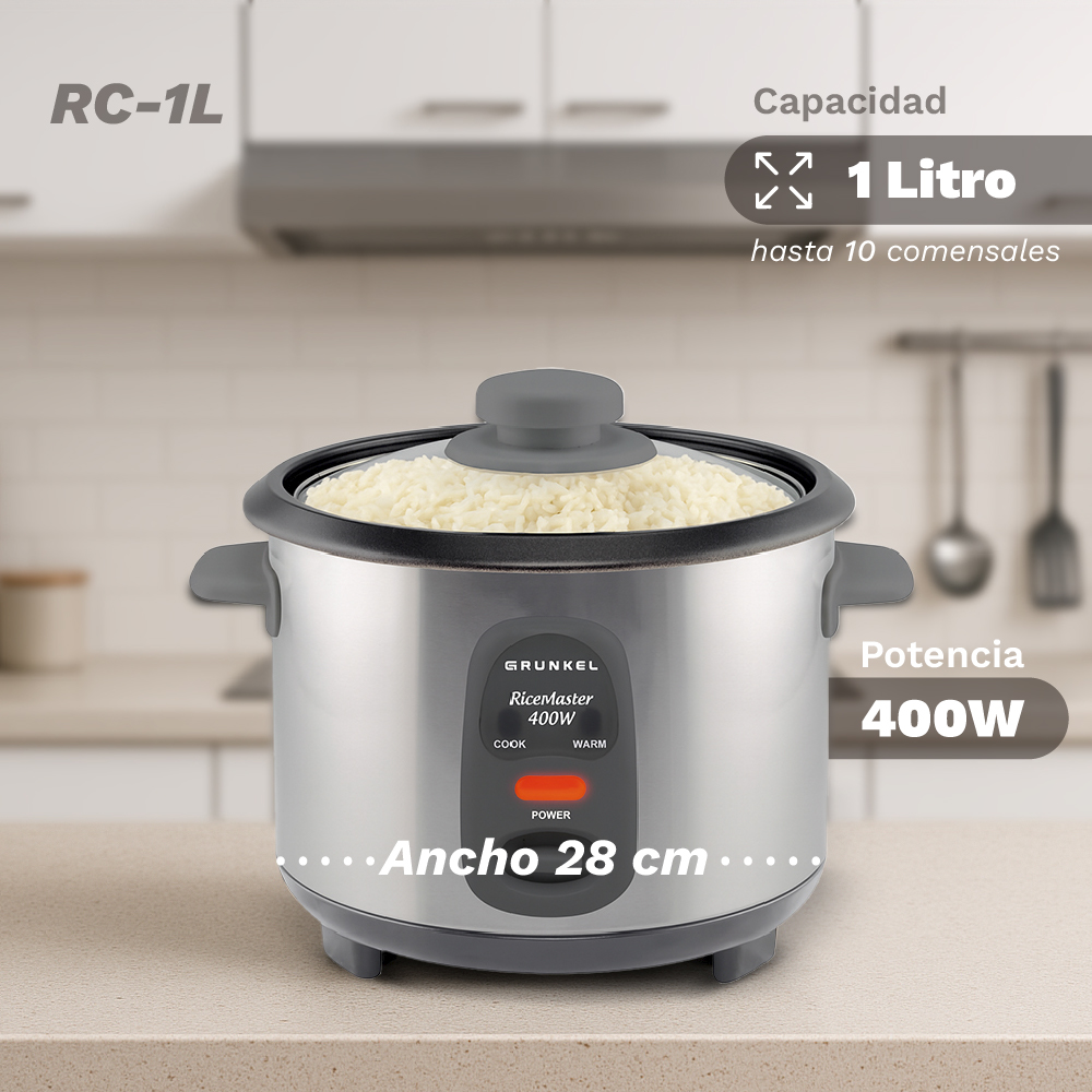 Una arrocera plateada con tapa de cristal está sobre una encimera. Capacidad de 1 litro.