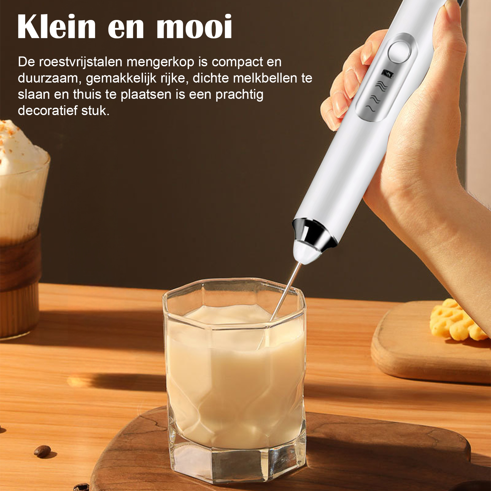 Ein weißer Milchaufschäumer wird in einem Glas Milch verwendet. Daneben liegt ein Keks.