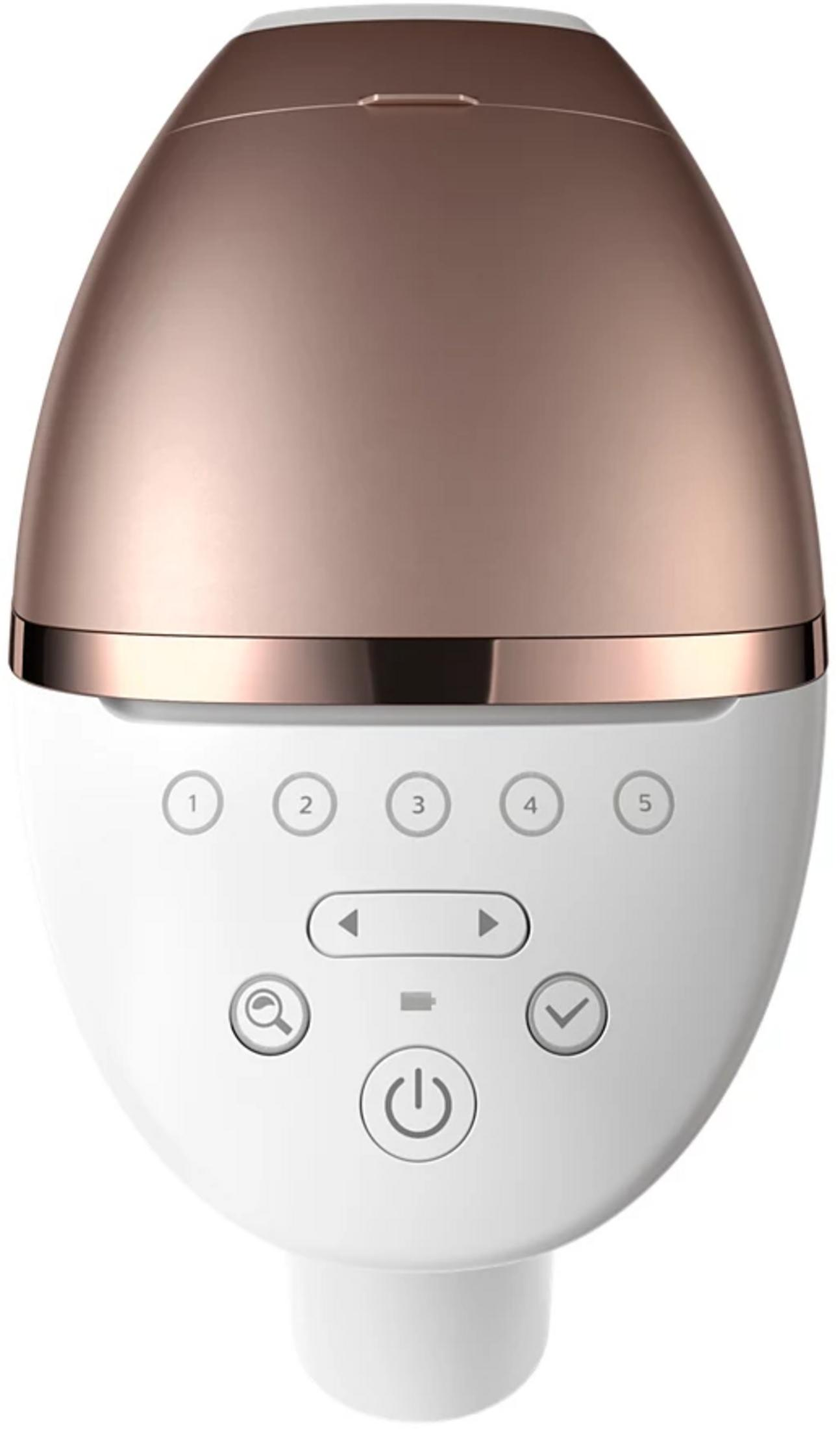 Un dispositivo blanco y oro rosa con botones y un símbolo de encendido.