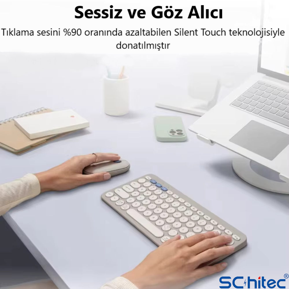 Bir kişi, dizüstü bilgisayar ve telefon yanında fare ve klavye kullanıyor.